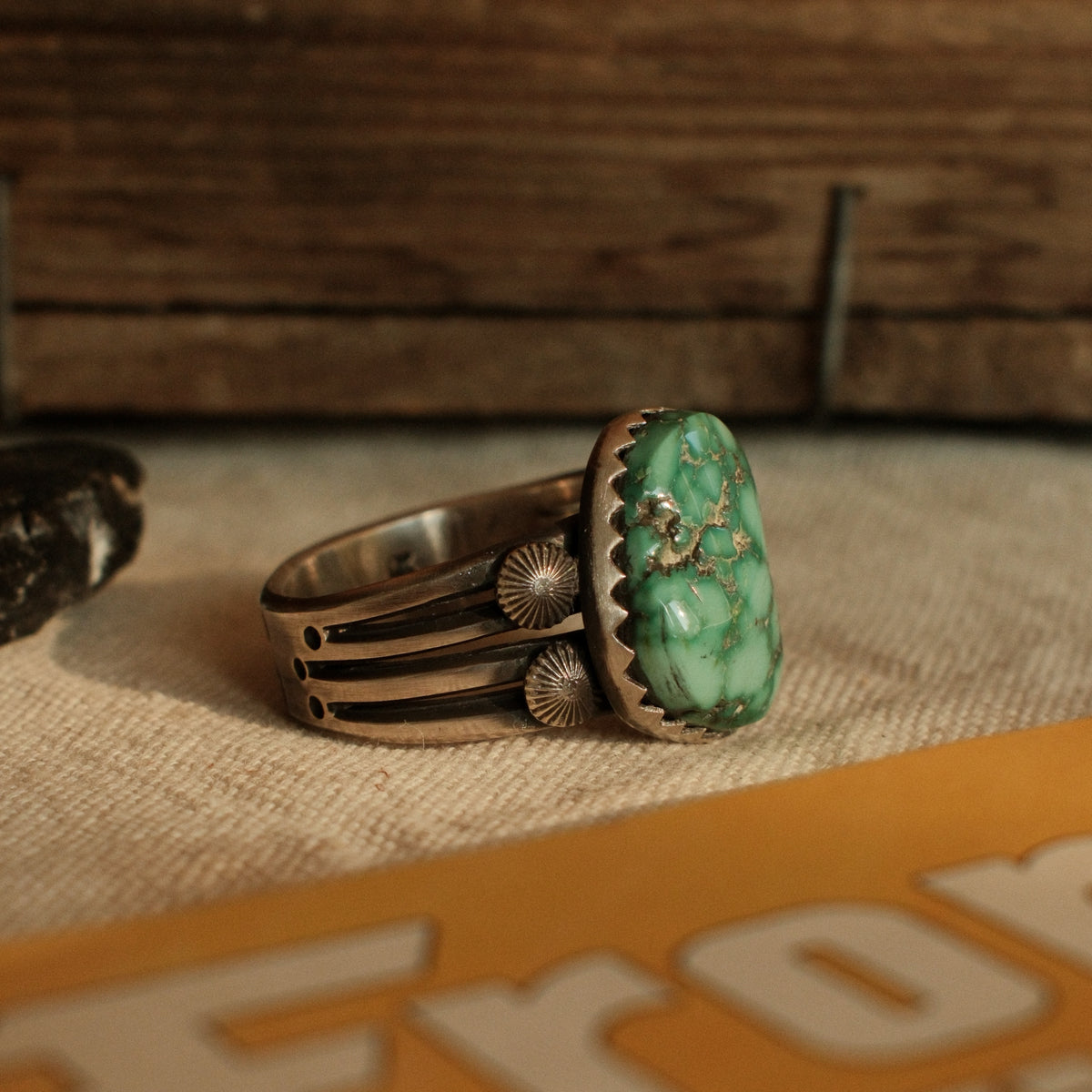 A one-of-a-kind 15×19mm nugget cut Fox turquoise in a hand filed serrated bezel on a four-prong split shank with starburst conchos, stamped across the back — view 2