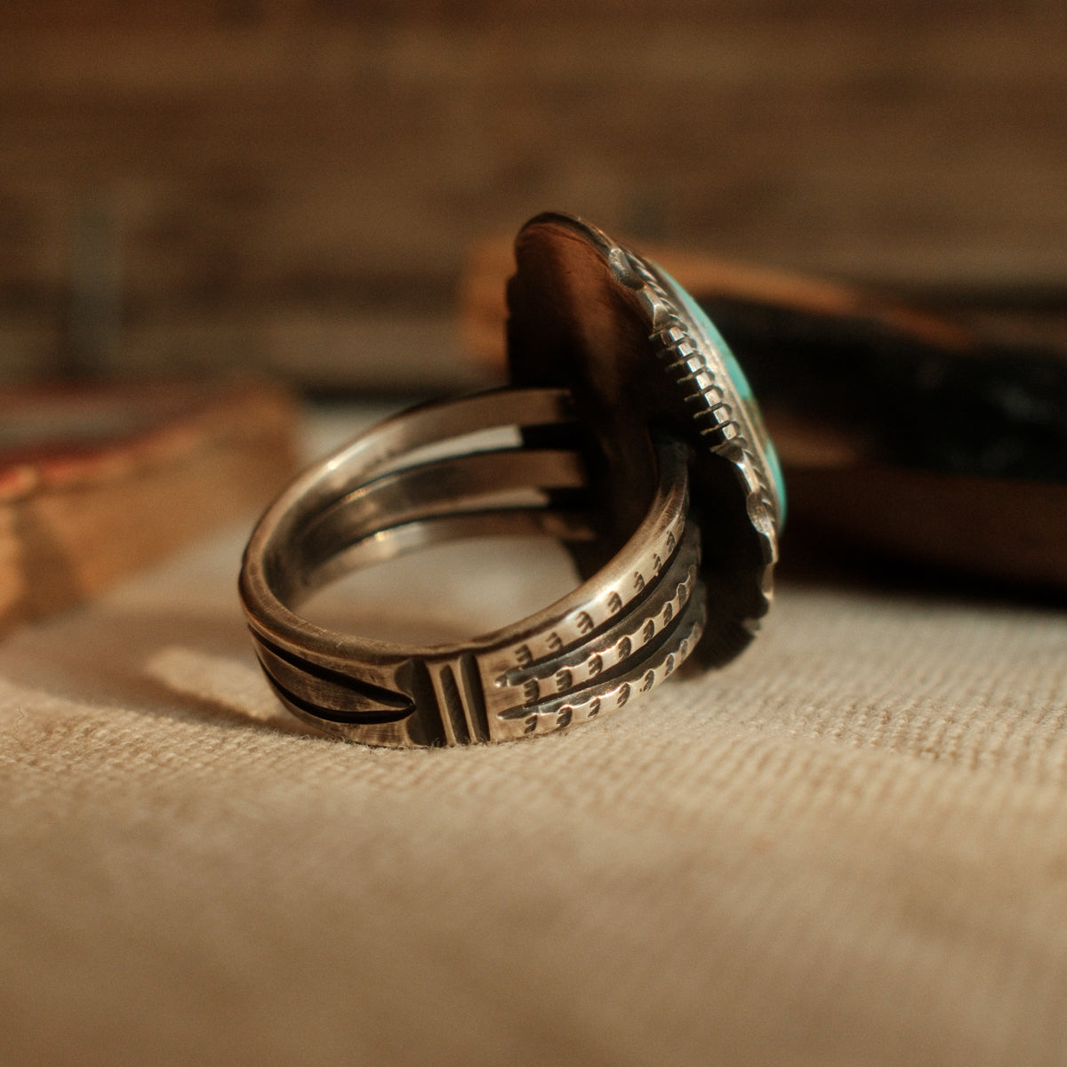 A one-of-a-kind 12×19mm Carico Lake turquoise in a straight bezel inside a twist wire border, on a three-prong stamped split shank — view 2