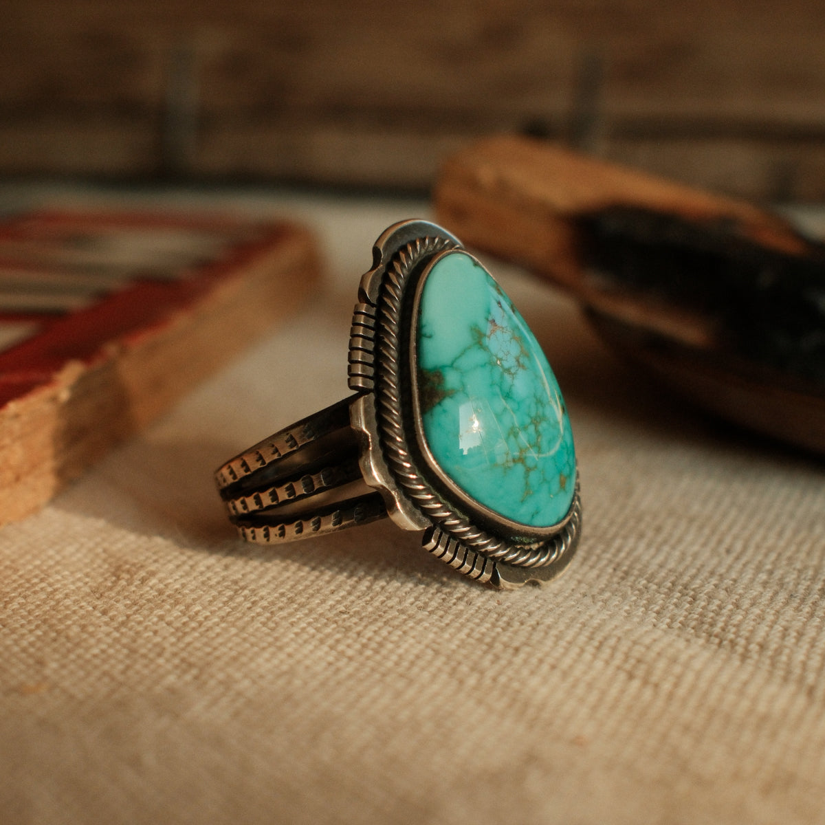 A one-of-a-kind 12×19mm Carico Lake turquoise in a straight bezel inside a twist wire border, on a three-prong stamped split shank — view 4