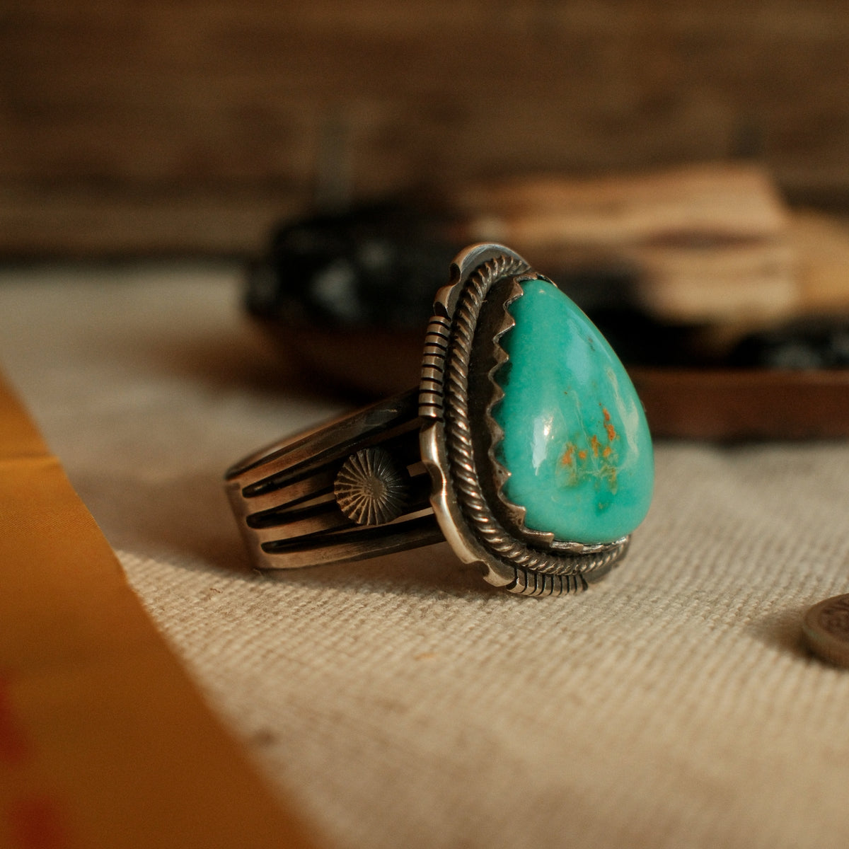 A one-of-a-kind 13×17mm Royston turquoise in a hand filed serrated bezel inside a twist wire border, conchos on the split shank, stamped across the back — view 2