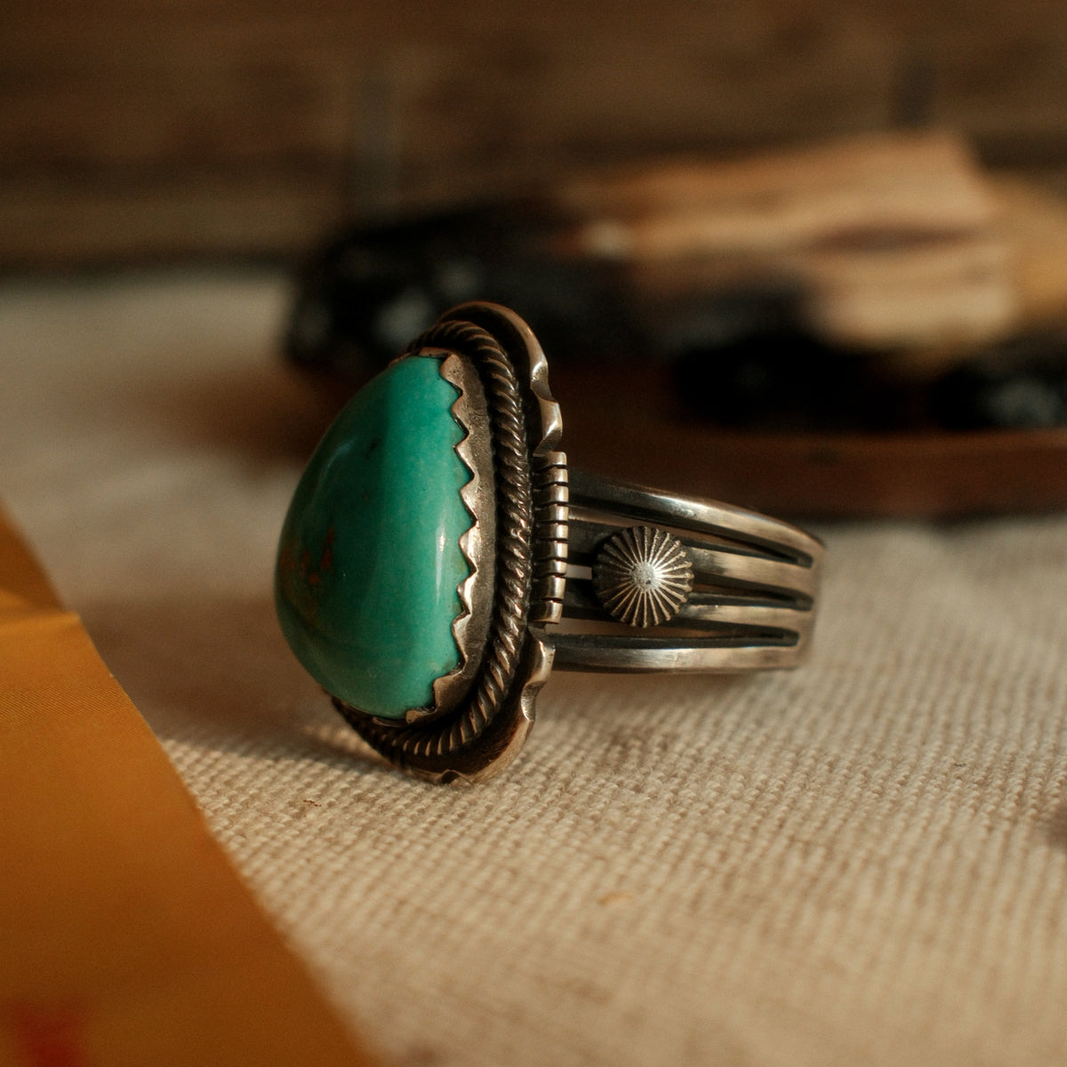 A one-of-a-kind 13×17mm Royston turquoise in a hand filed serrated bezel inside a twist wire border, conchos on the split shank, stamped across the back — view 5