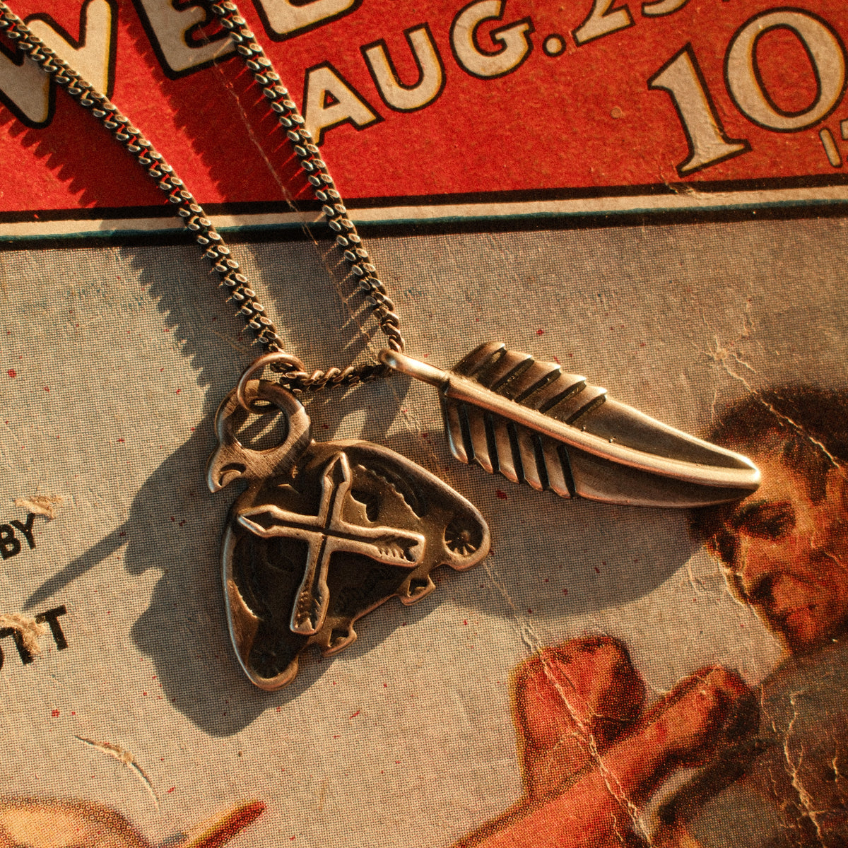 A solid sterling silver curb chain rooted in saddlery and early-hardware design — flat-laying interlocked links with a deep hand-applied patina.