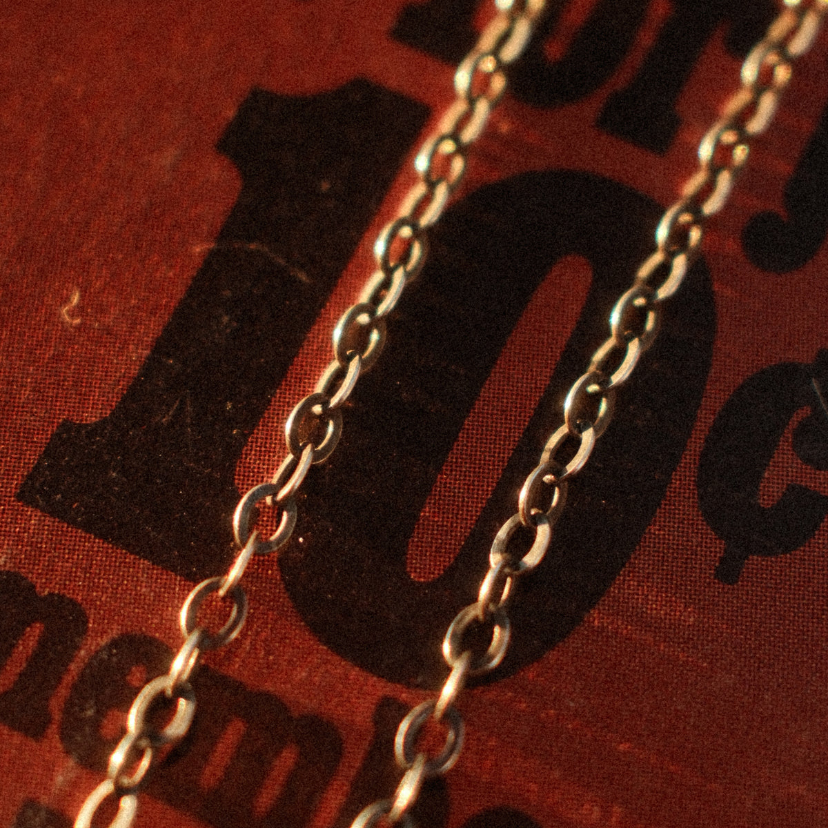 A lightweight sterling silver cable chain with flat oval links in 16 to 20 inch lengths, finished with a lobster clasp and a hand-applied patina.