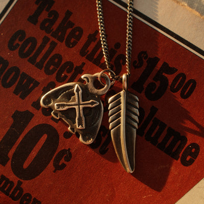 A solid sterling silver curb chain rooted in saddlery and early-hardware design — flat-laying interlocked links with a deep hand-applied patina.