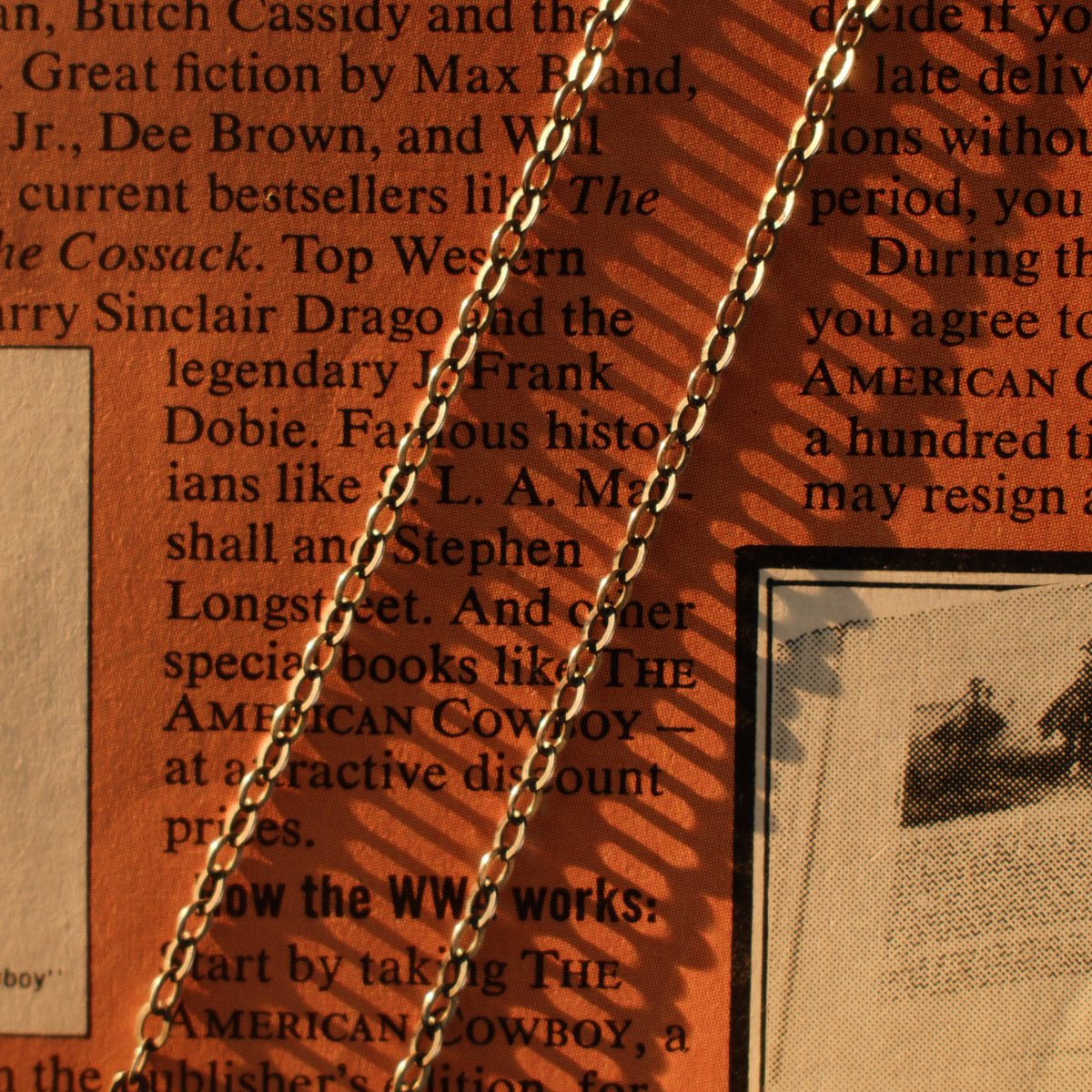 A lightweight sterling silver cable chain with flat oval links in 16 to 20 inch lengths, finished with a lobster clasp and a hand-applied patina.