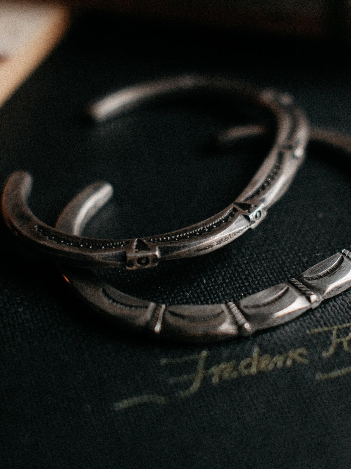 A tufa-cast coin-silver ingot cuff, intricately hand-stamped with Chad's own steel and left in its raw casting texture — view 2