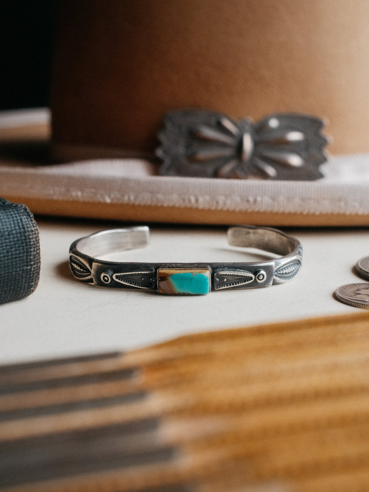 Poured from a tufa-cast ingot and hand-stamped with Chad's own steel, set with a piece of Royston turquoise