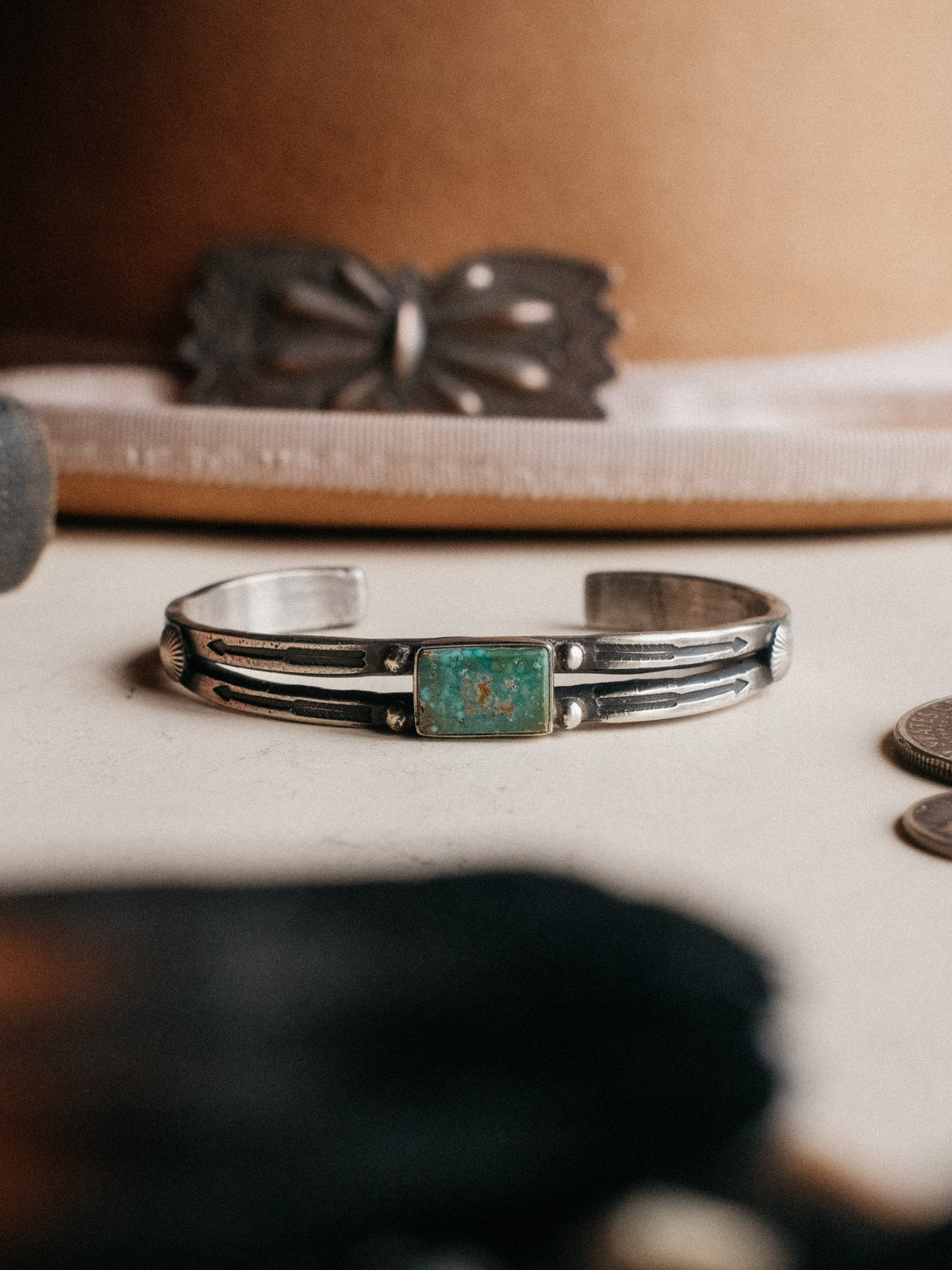 A split cuff poured from a tufa-cast ingot and hand-stamped, set with Royston turquoise from Nevada — view 2