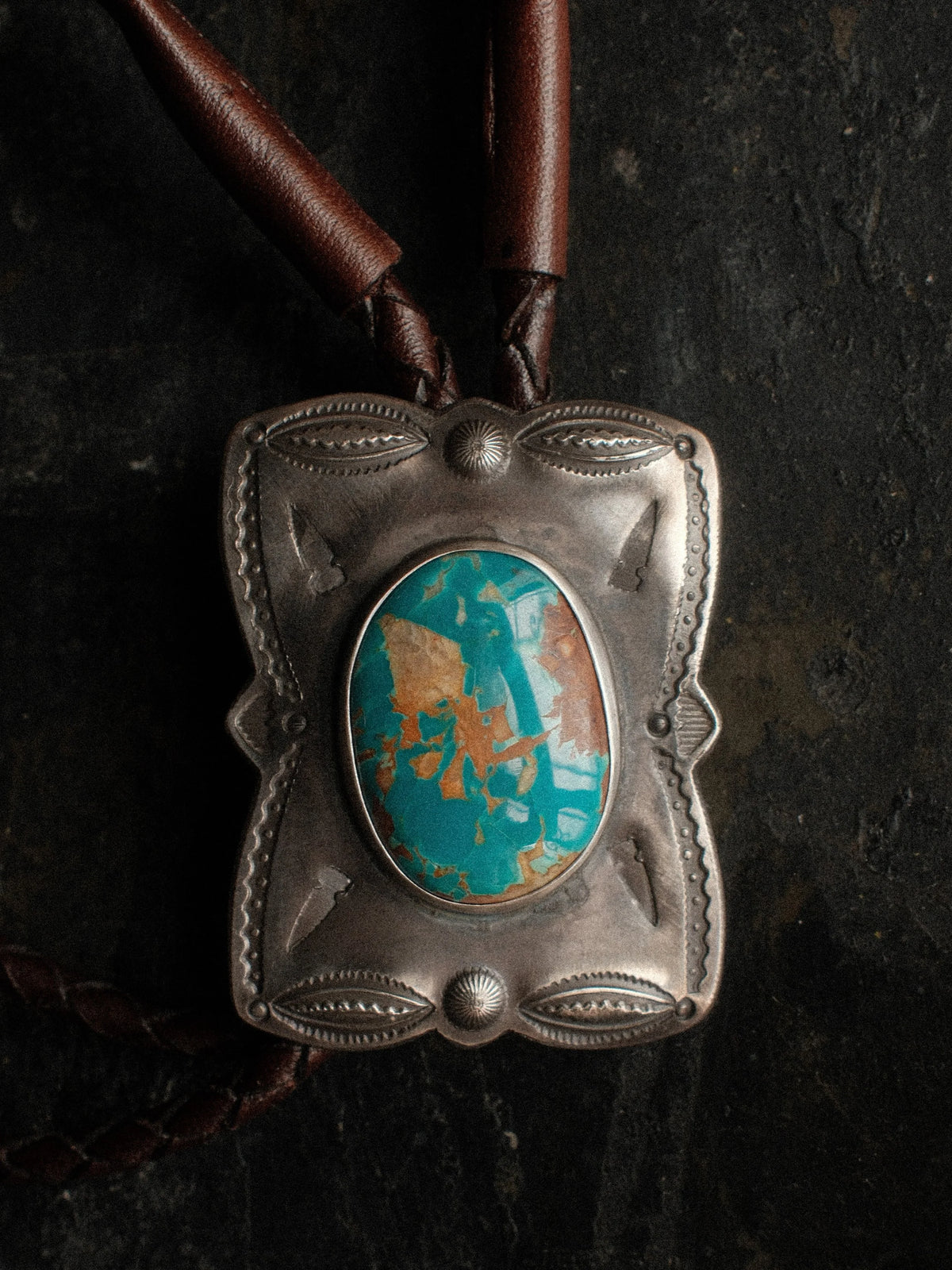 Royston turquoise from Nevada, hand-stamped with bump-outs for dimension and finished with sterling tips on a braided leather cord — view 2