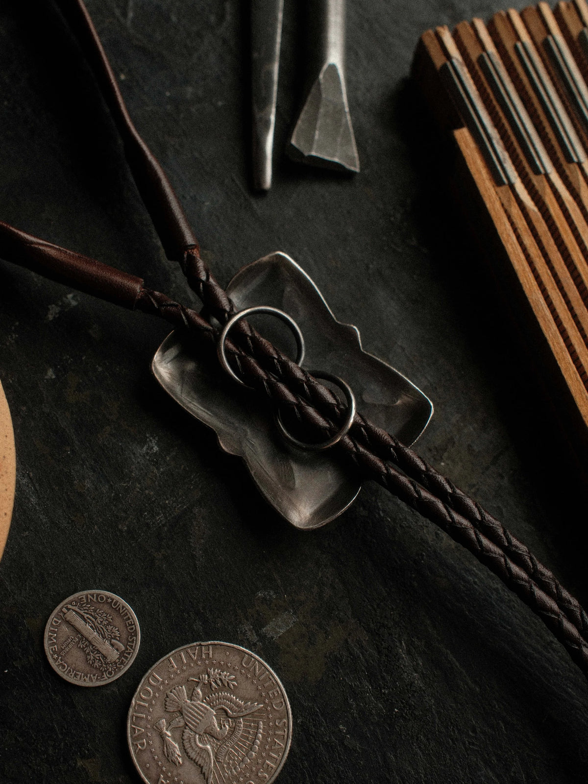 Royston turquoise from Nevada, hand-stamped with bump-outs for dimension and finished with sterling tips on a braided leather cord — view 3