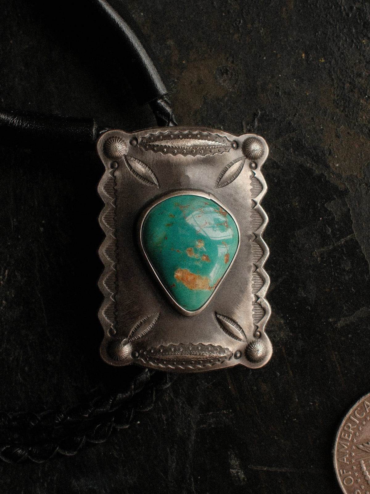 A Royston turquoise bolo, hand-stamped for dimension and set on braided leather with sterling end tips — view 2