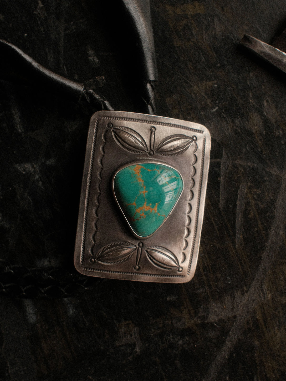 Hand-stamped with bump-outs and centered on Royston turquoise from Nevada, strung on braided leather with sterling tips — view 2
