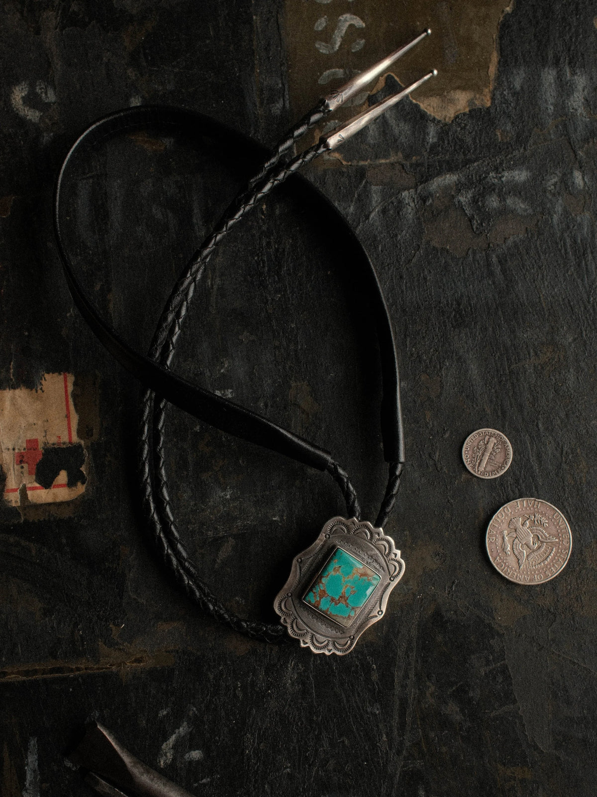 Royston turquoise from Nevada, hand-stamped with bump-outs for dimension, on a braided leather cord with sterling tips.