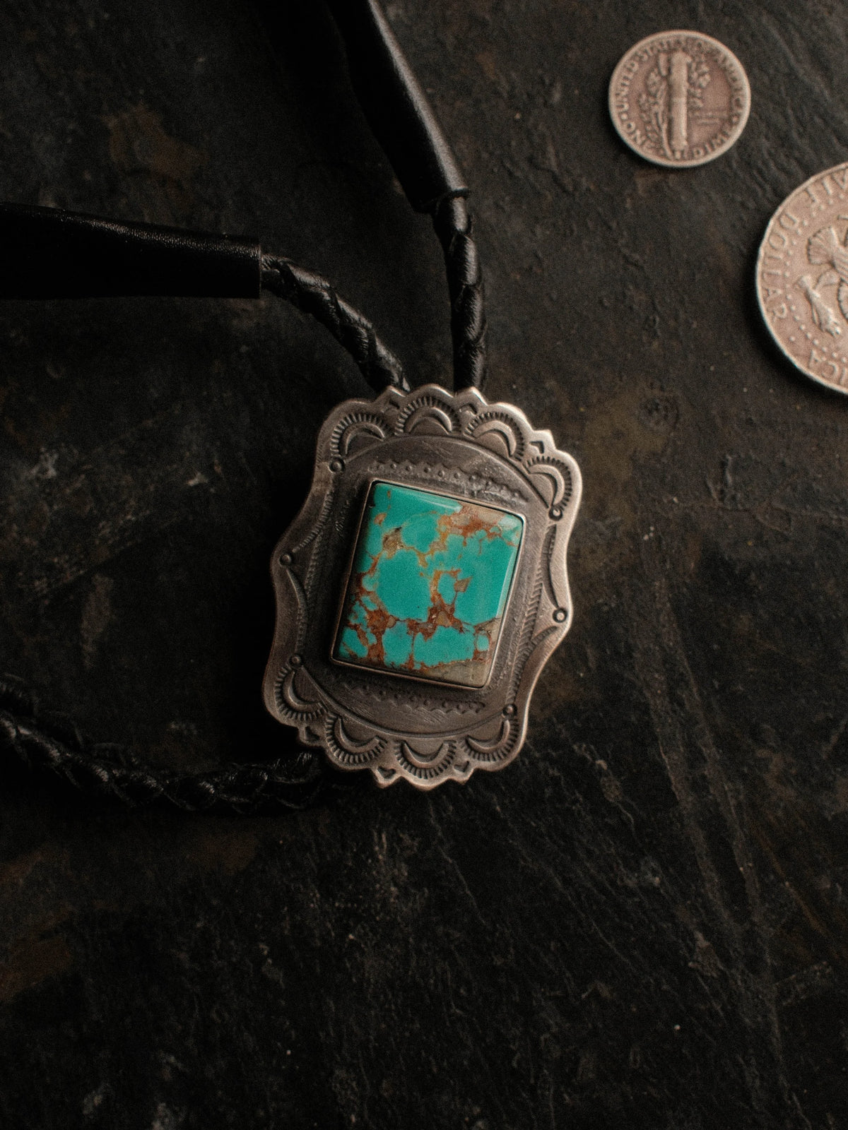 Royston turquoise from Nevada, hand-stamped with bump-outs for dimension, on a braided leather cord with sterling tips. — view 2