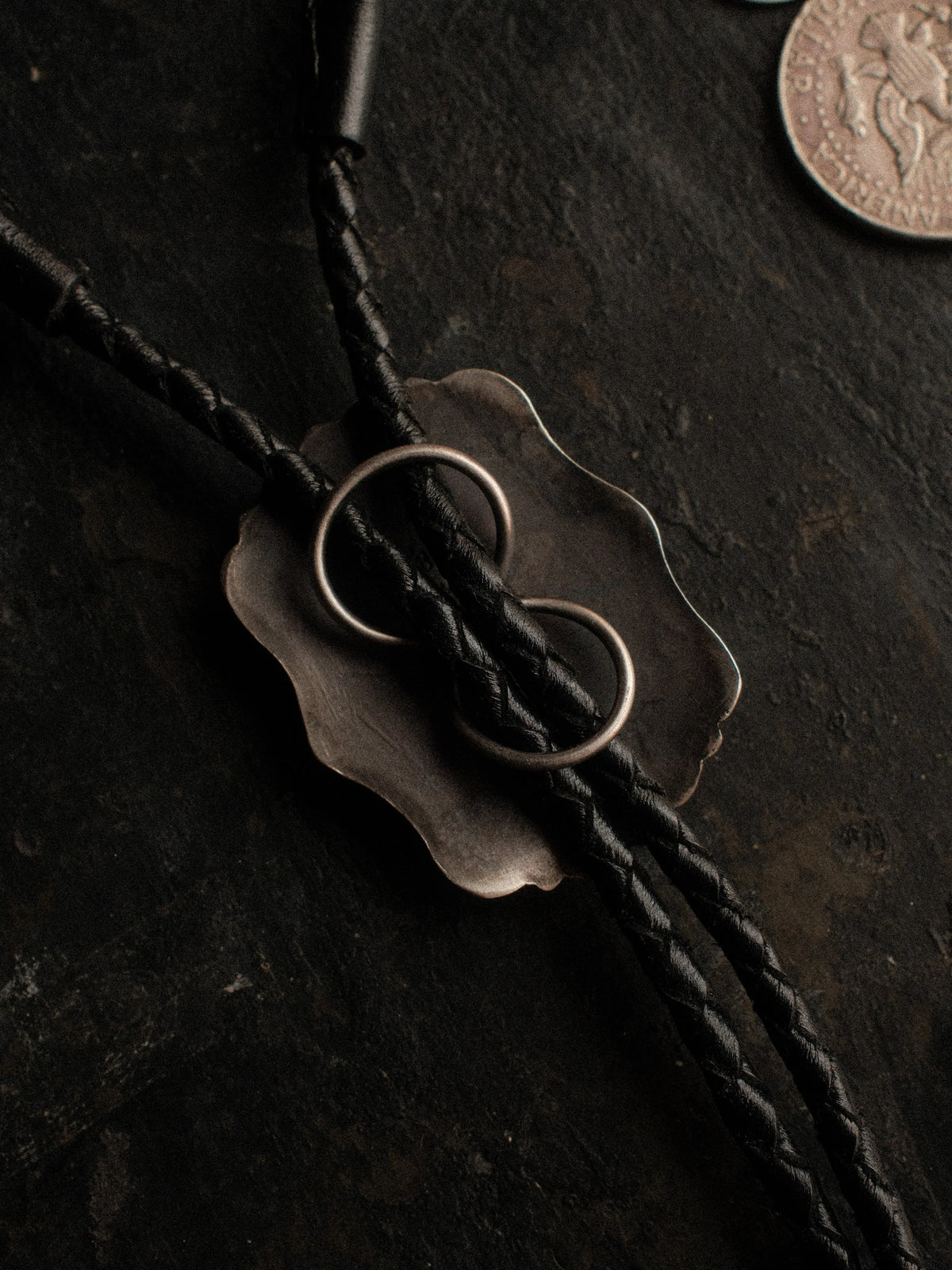 Royston turquoise from Nevada, hand-stamped with bump-outs for dimension, on a braided leather cord with sterling tips. — view 3