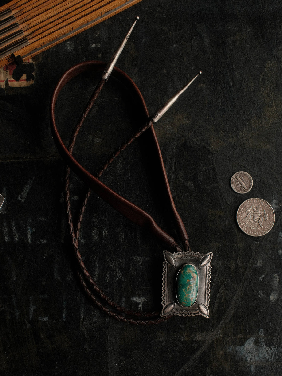 Royston turquoise on a hand-stamped slide with bump-out detailing, set on braided leather with sterling tips