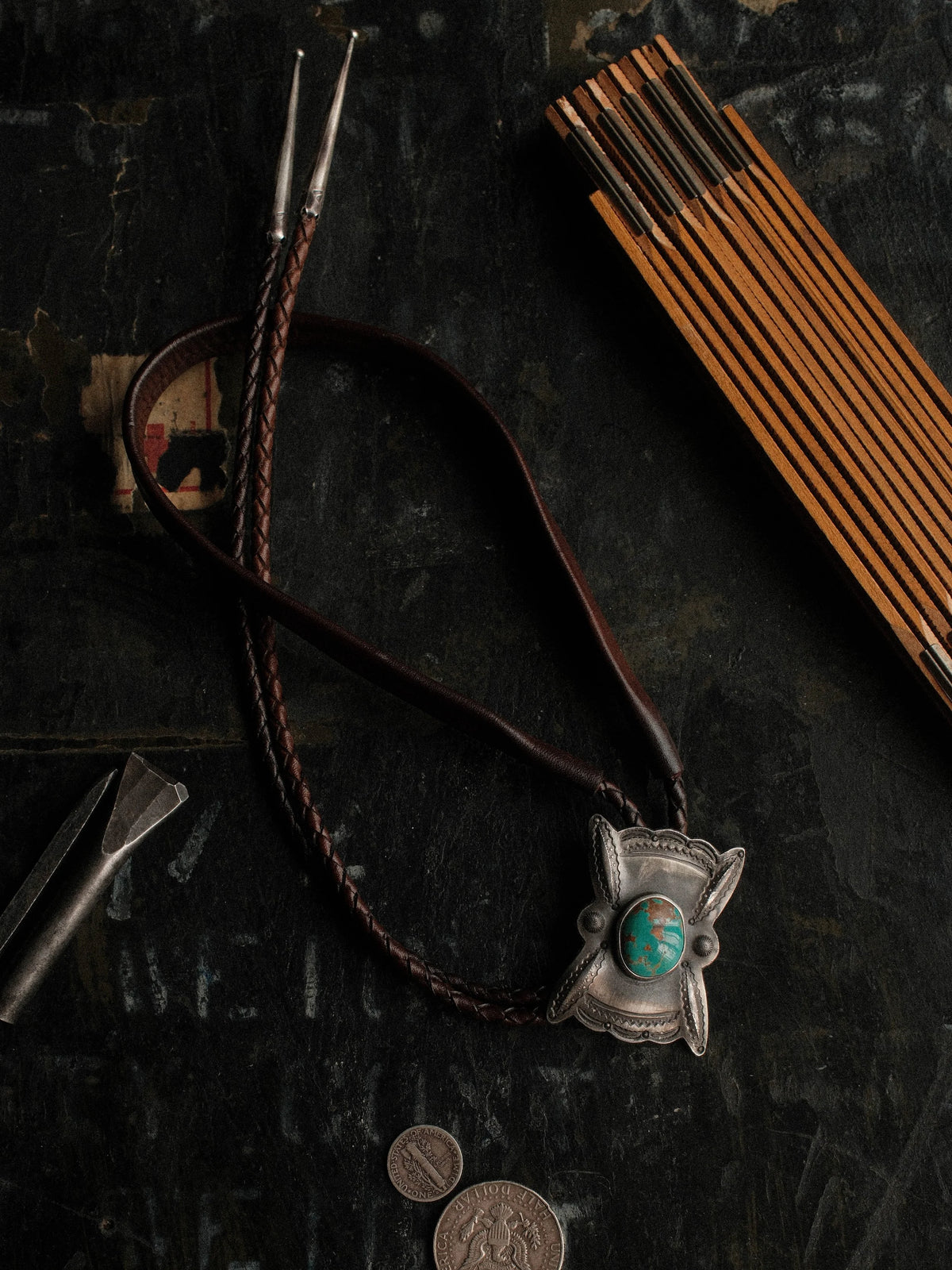 Royston turquoise from Nevada, hand-stamped with bump-outs for dimension, on a braided leather cord with sterling tips.