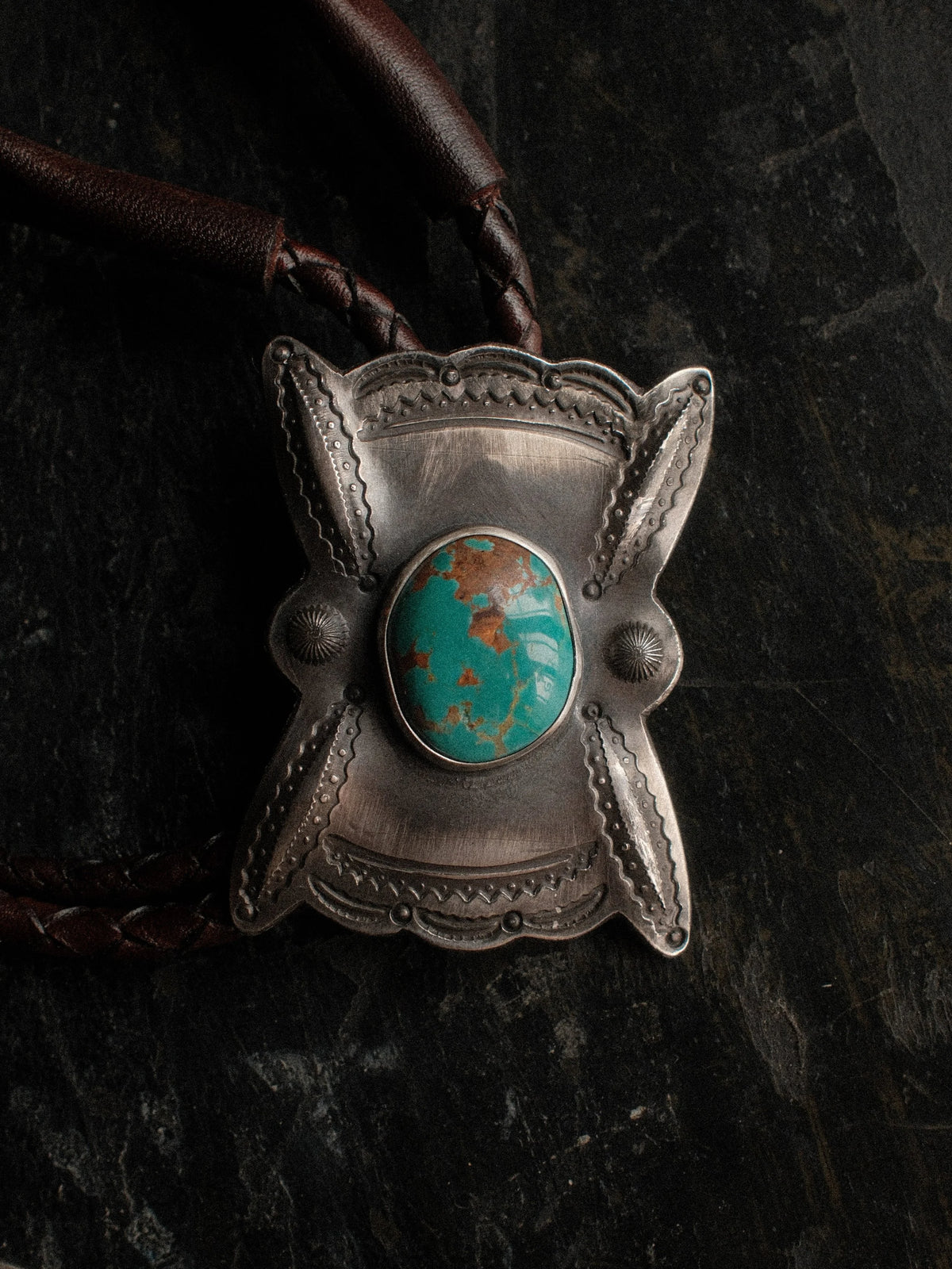 Royston turquoise from Nevada, hand-stamped with bump-outs for dimension, on a braided leather cord with sterling tips. — view 2