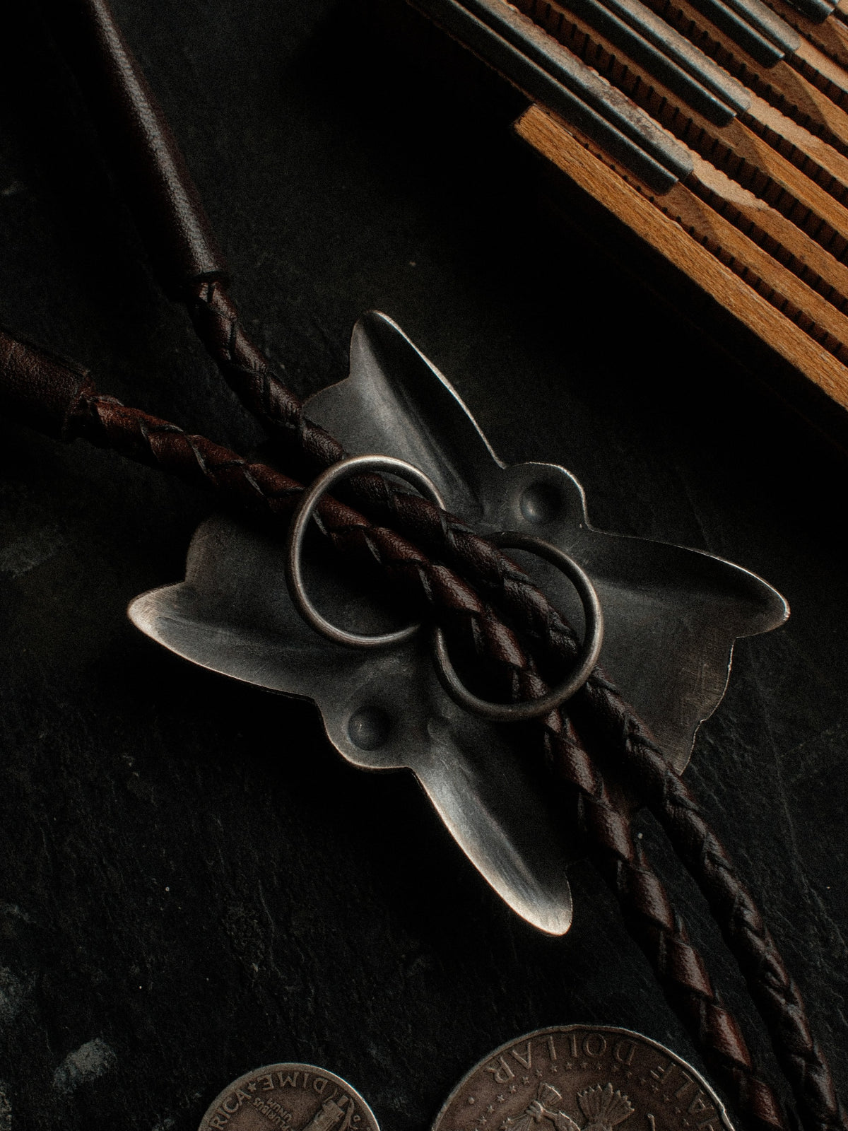 Royston turquoise from Nevada, hand-stamped with bump-outs for dimension, on a braided leather cord with sterling tips. — view 3