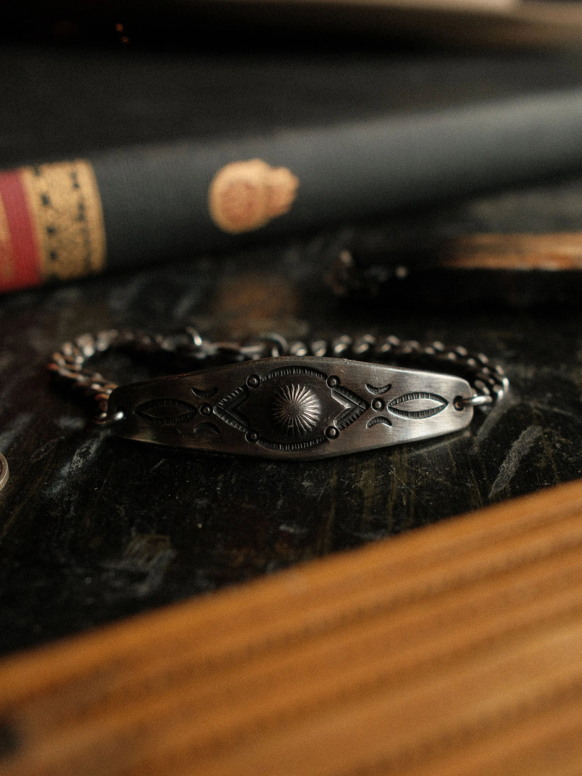 A hand-stamped ID plate set on a sturdy curb chain with our sister-hook clasp and finished in a deep patina