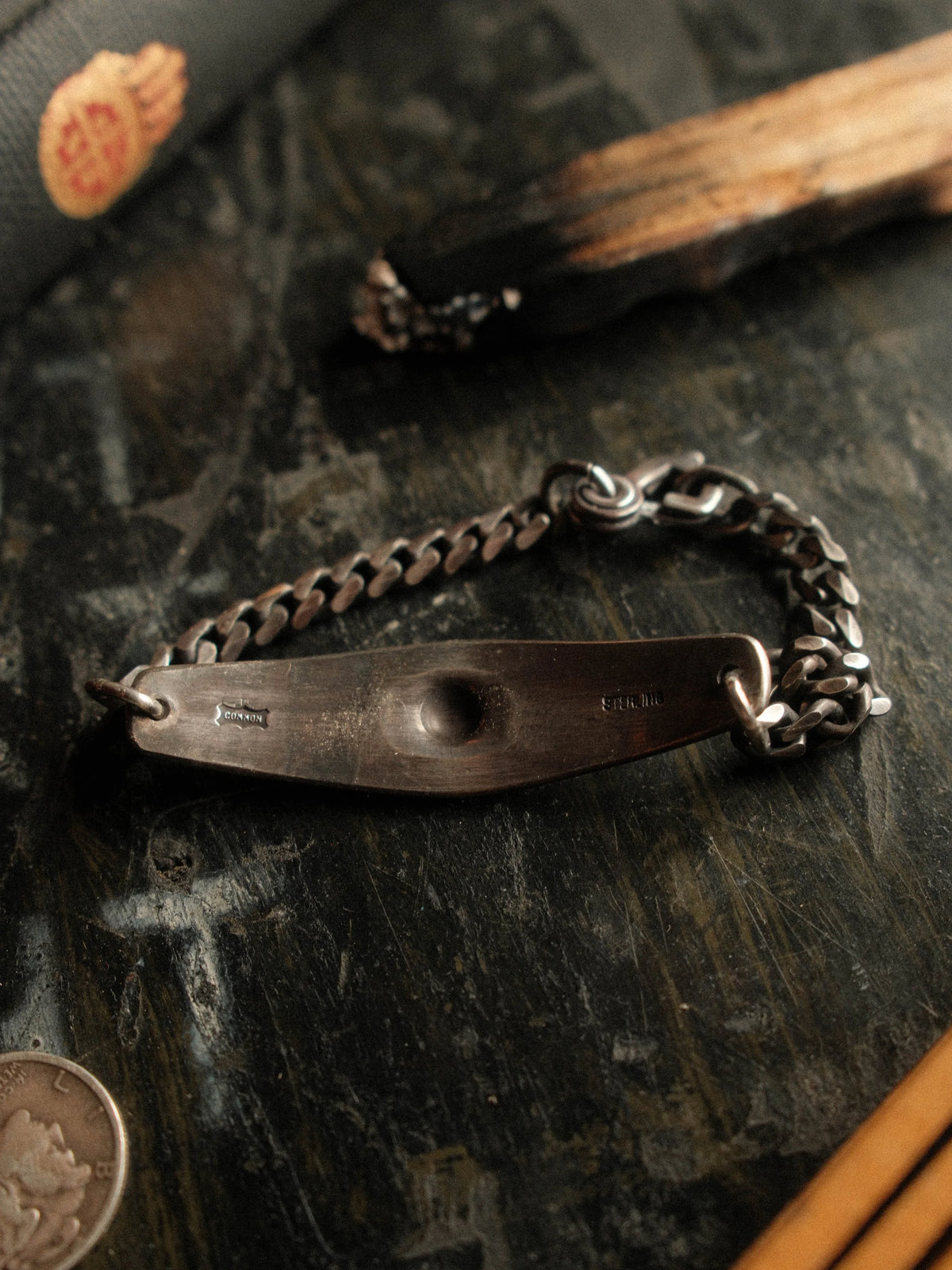 A hand-stamped ID plate set on a sturdy curb chain with our sister-hook clasp and finished in a deep patina — view 3