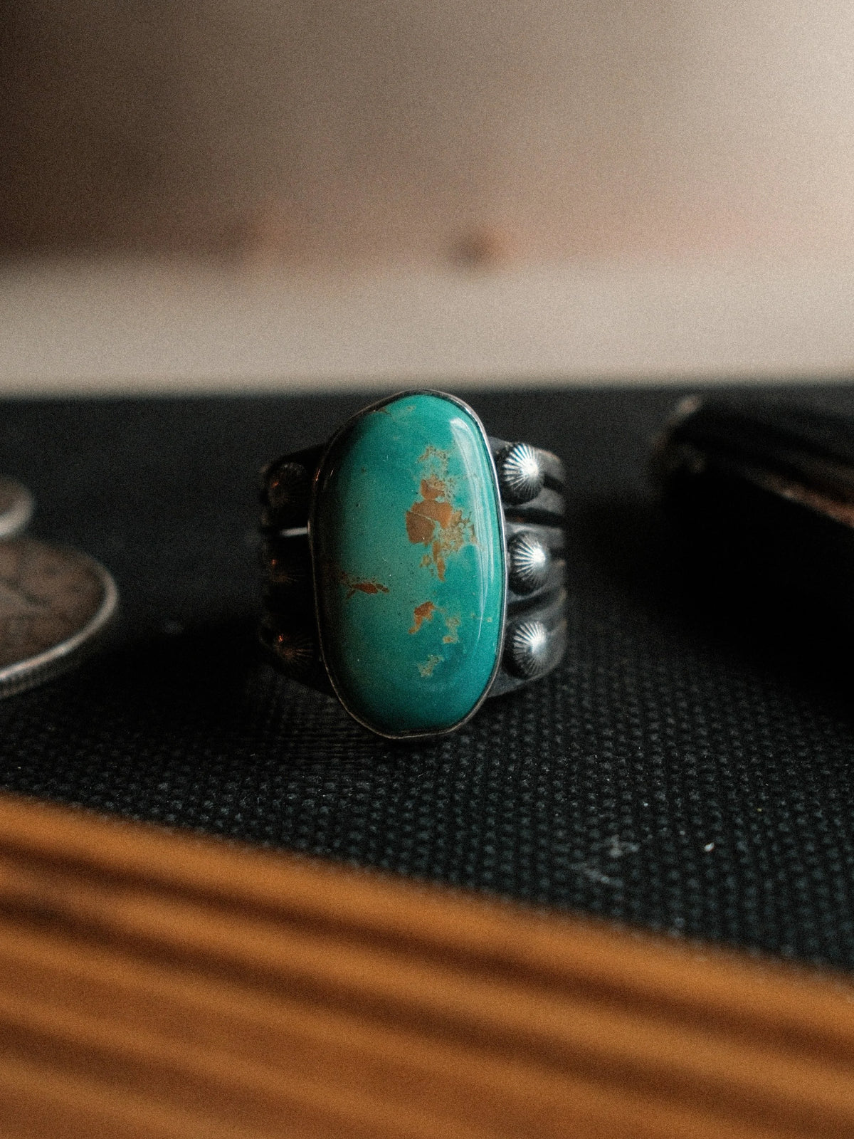 A 12×21mm Royston turquoise stone on a six-prong split shank with concho details, hand-stamped.