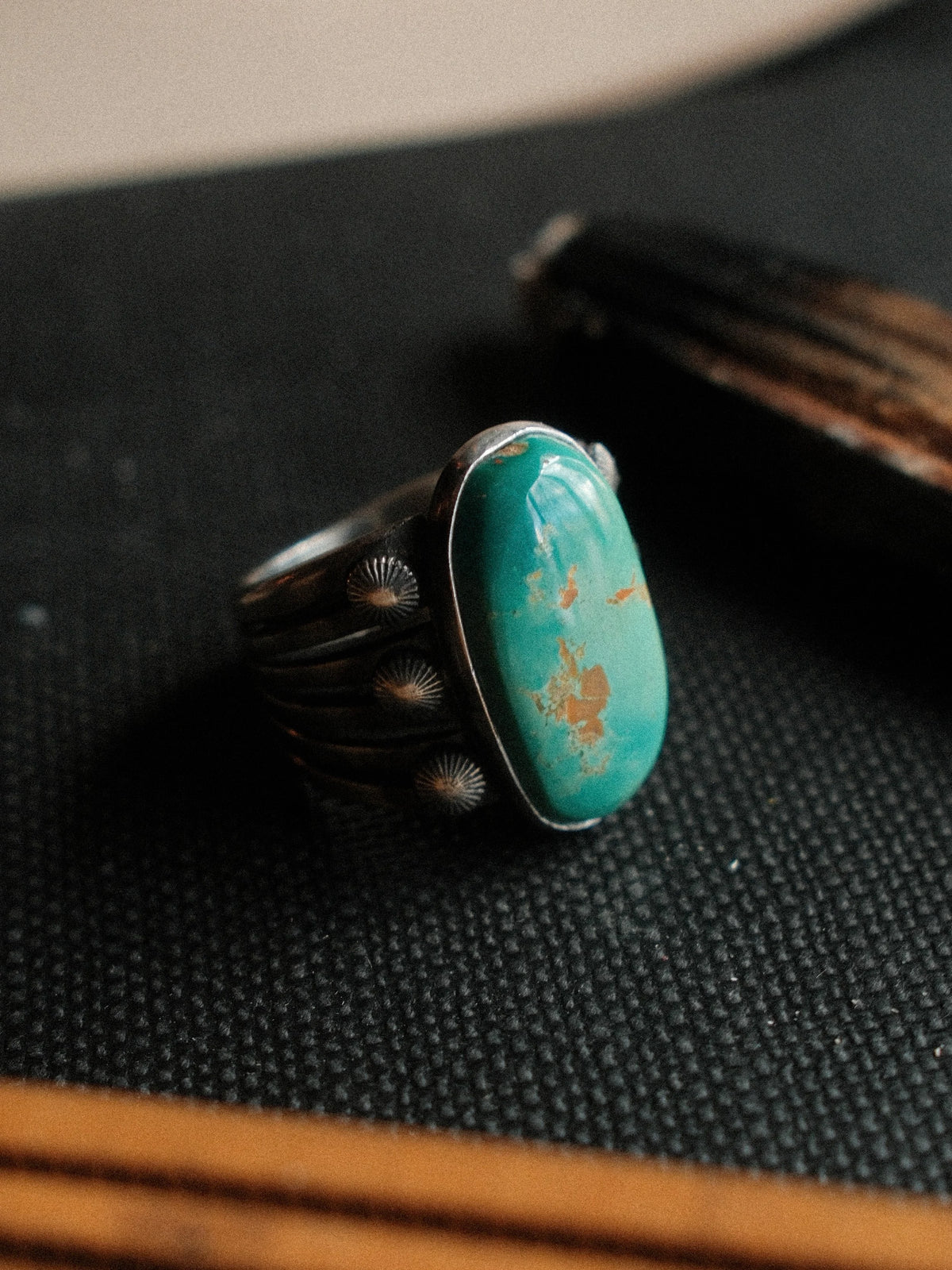 A 12×21mm Royston turquoise stone on a six-prong split shank with concho details, hand-stamped. — view 4