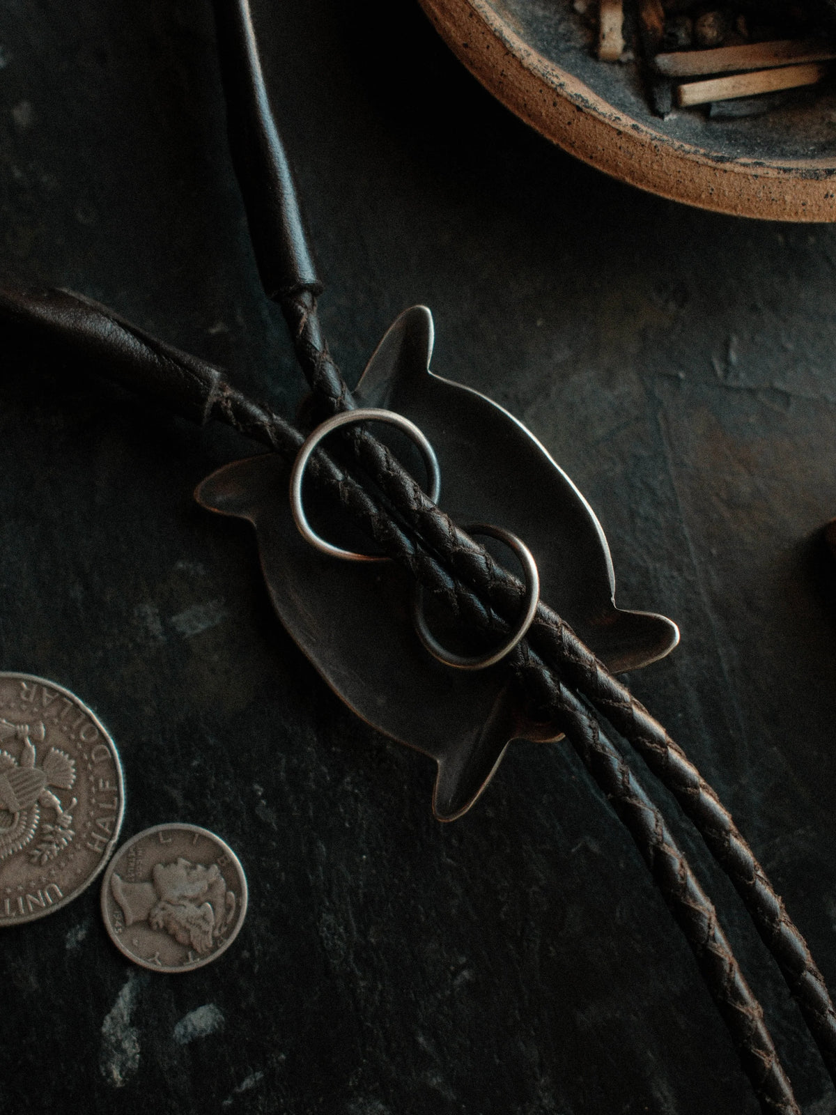 Royston turquoise from Nevada, hand-stamped with bump-outs for dimension, on a braided leather cord with sterling tips. — view 2