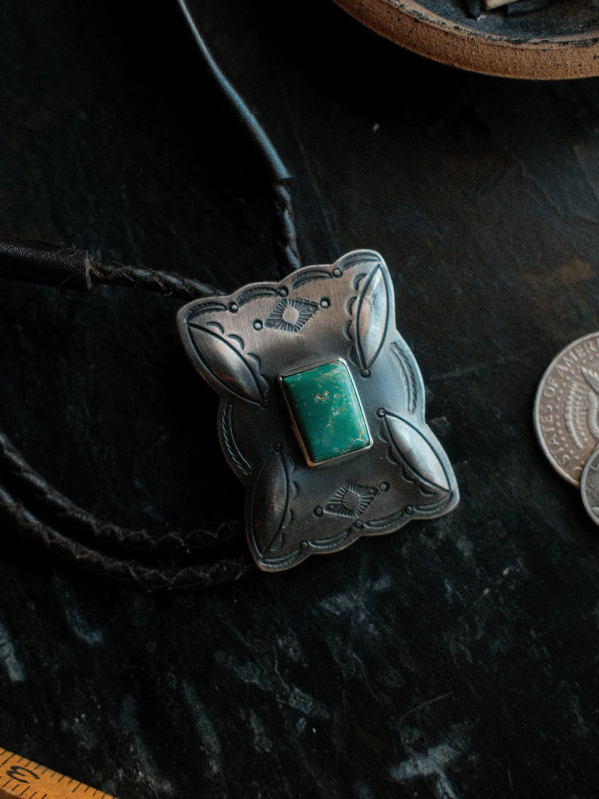 Royston turquoise from Nevada, hand-stamped with bump-outs for dimension, on a braided leather cord with sterling tips. — view 2