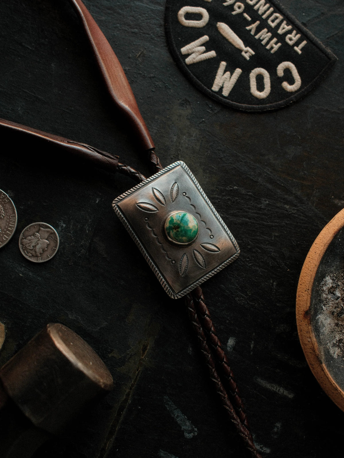 Royston turquoise from Nevada, hand-stamped for dimension and set on a braided leather cord with sterling tips