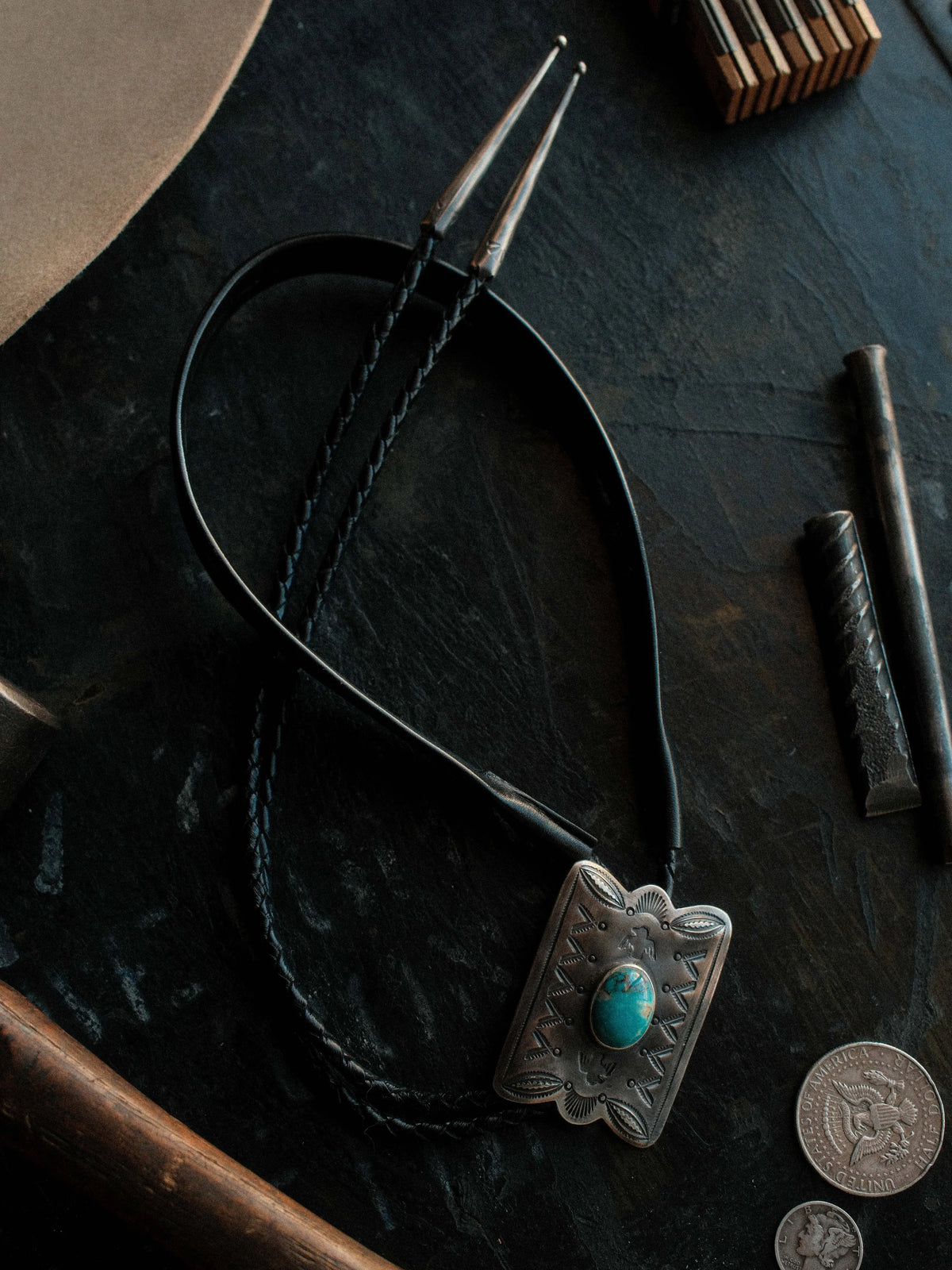 Royston turquoise from Nevada, hand-stamped with bump-outs for dimension, on a braided leather cord with sterling tips. — view 2