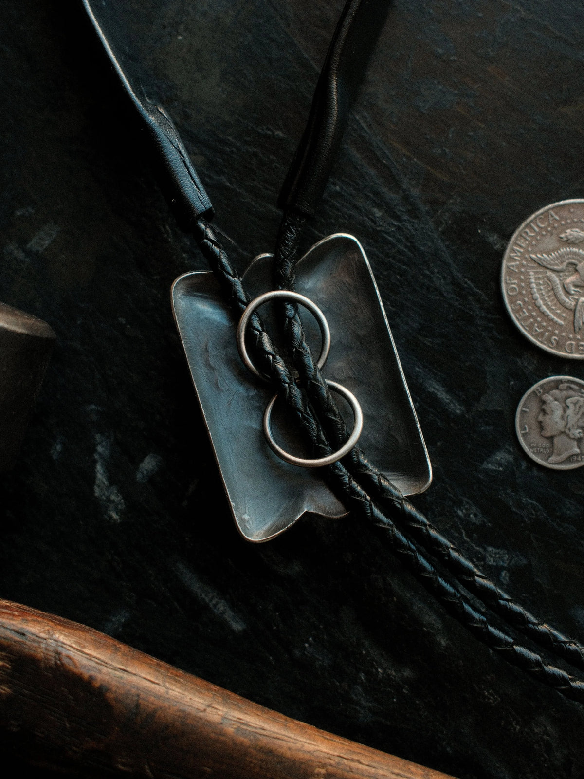 Royston turquoise from Nevada, hand-stamped with bump-outs for dimension, on a braided leather cord with sterling tips. — view 3