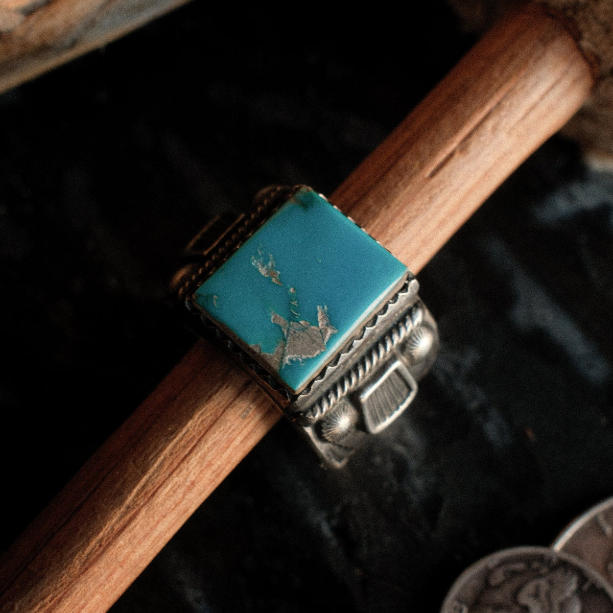 Kingman turquoise in a hand-filed serrated bezel on a tiered sterling base, hand-stamped. One of a kind, size 9.