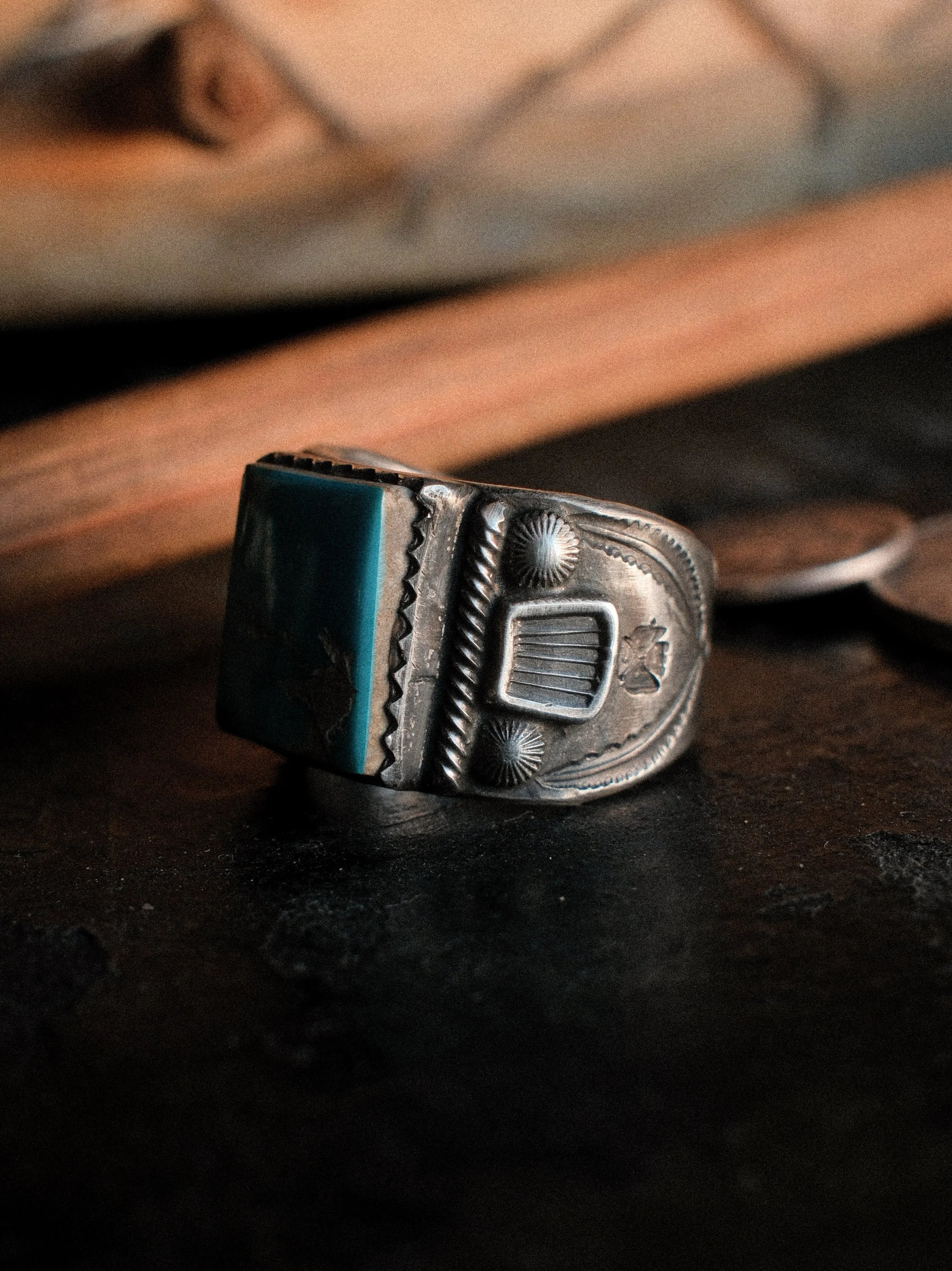 Kingman turquoise in a hand-filed serrated bezel on a tiered sterling base, hand-stamped — view 4