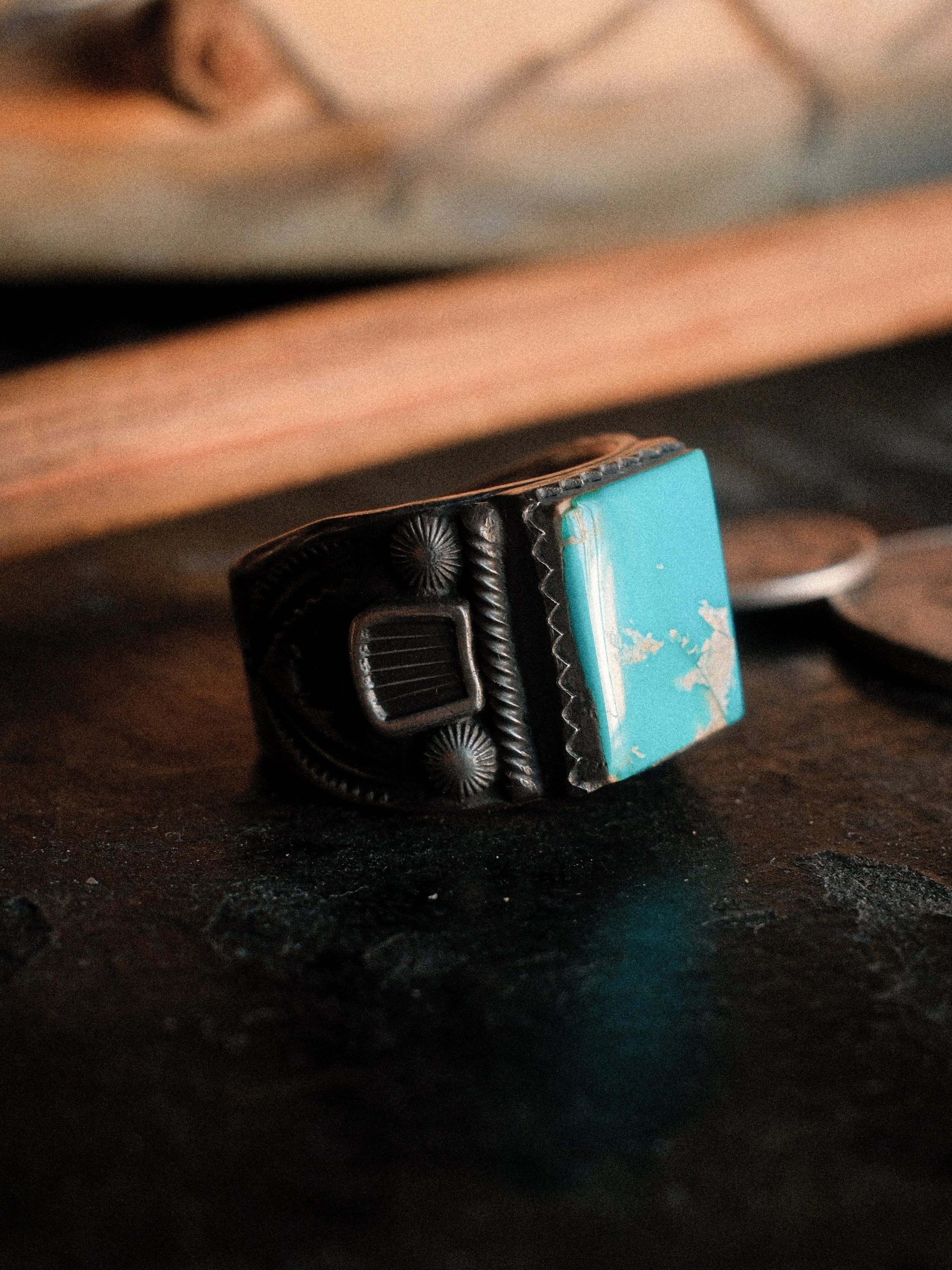 Kingman turquoise in a hand-filed serrated bezel on a tiered sterling base, hand-stamped — view 5