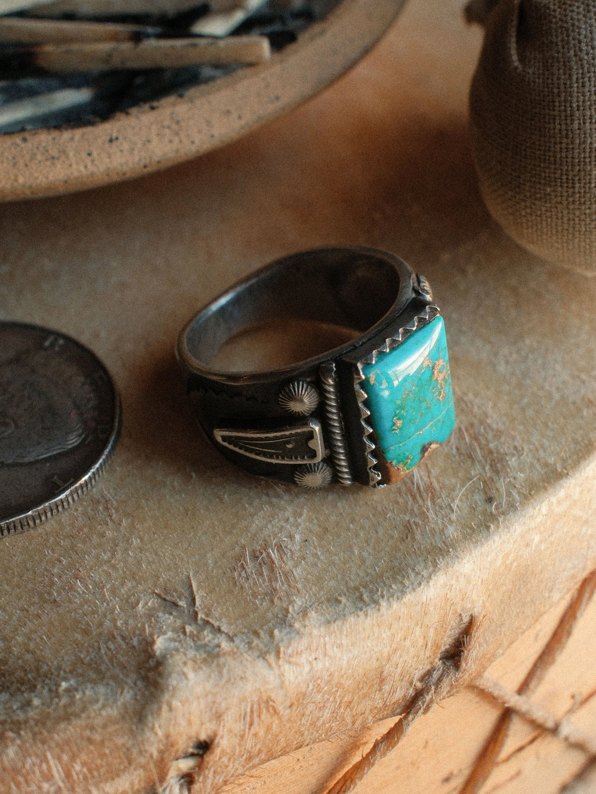 Kingman turquoise held in a hand-filed serrated bezel over a tiered, hand-stamped base — view 3