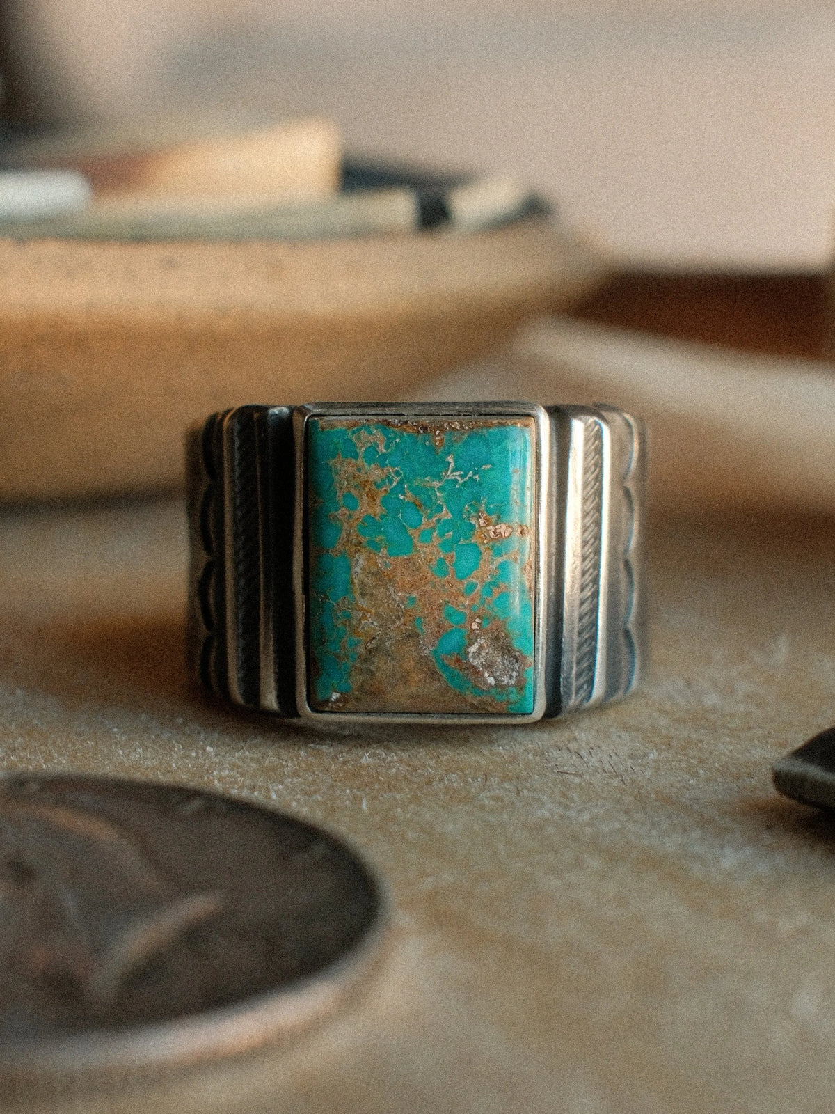 A Bandolero ring built on a sturdy tiered base and set with Kingman turquoise from Chad's private stash, hand-stamped throughout