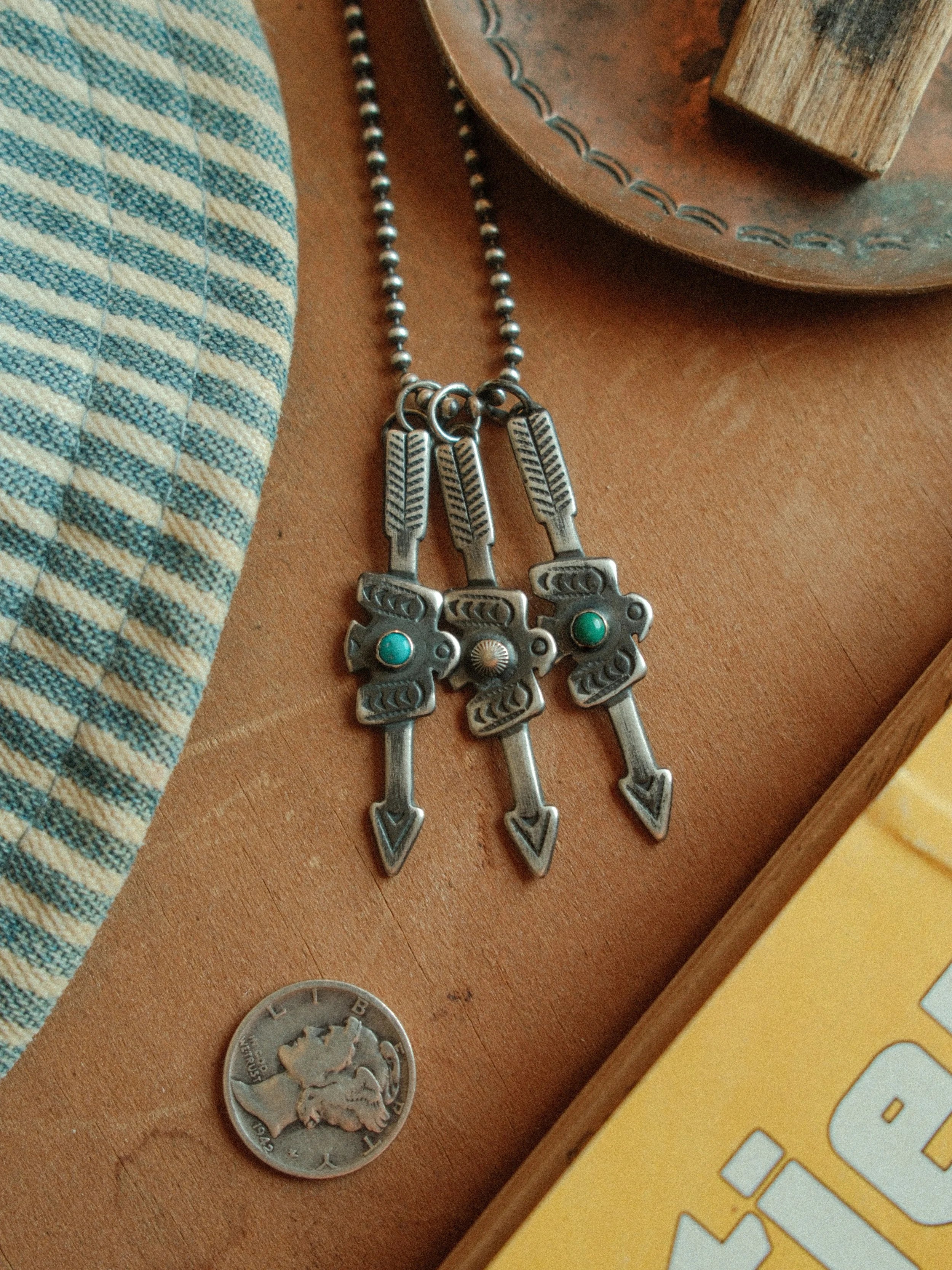 Arrow and thunderbird joined in fine sterling stampwork, centered with Carico Lake turquoise or a silver concho — view 3