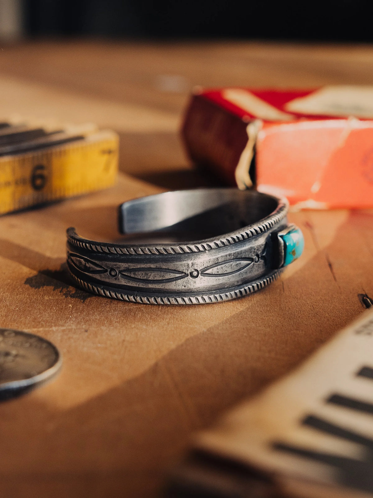 A tufa-cast ingot cuff intricately hand-stamped and set with a deep piece of Manassa turquoise from Colorado's dormant King mine — view 2