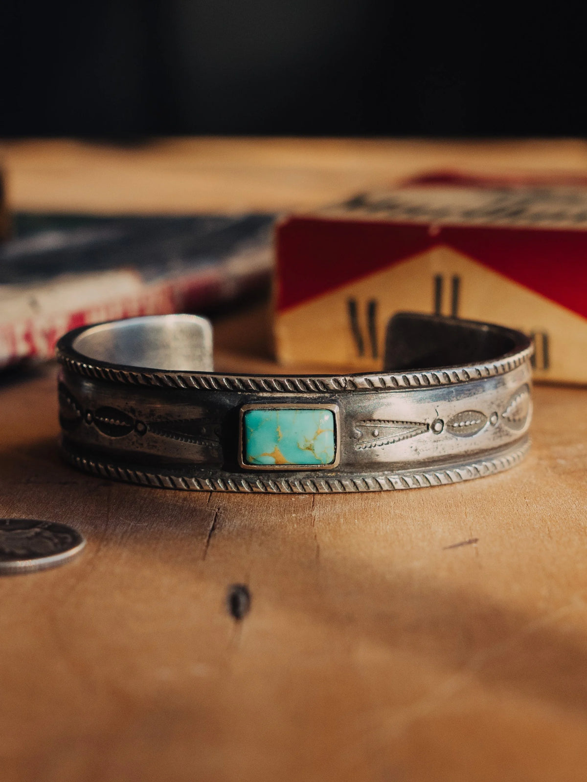 Poured from a tufa-cast ingot and hand-stamped throughout, set with Manassa turquoise from the long-closed King mine in Colorado