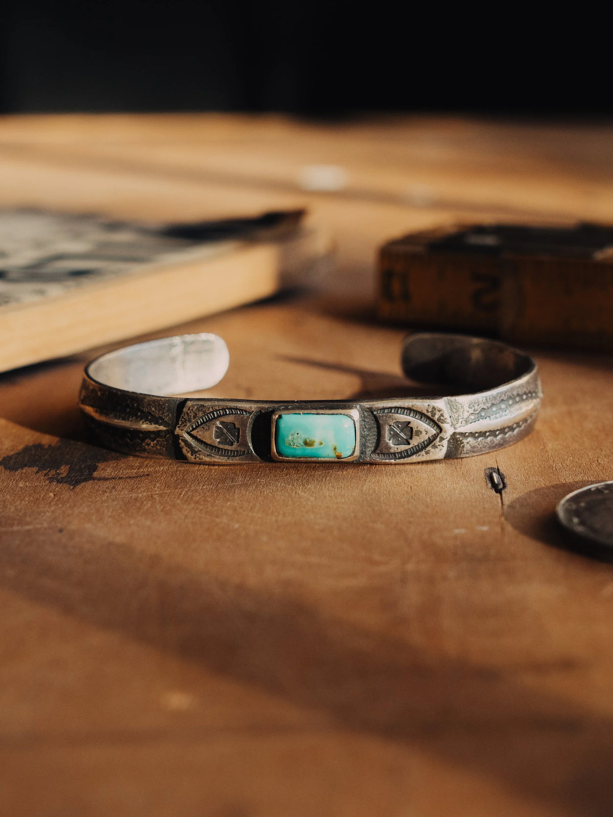 A coin-silver ingot cuff, tufa-cast and hand-stamped, centered on a piece of Manassa turquoise from Colorado