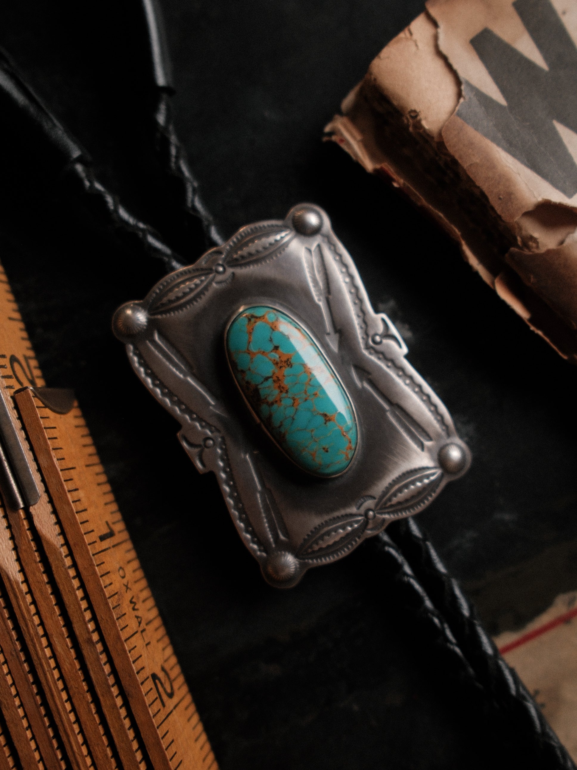 Nevada Royston turquoise on a hand-stamped sterling slide with braided leather cord