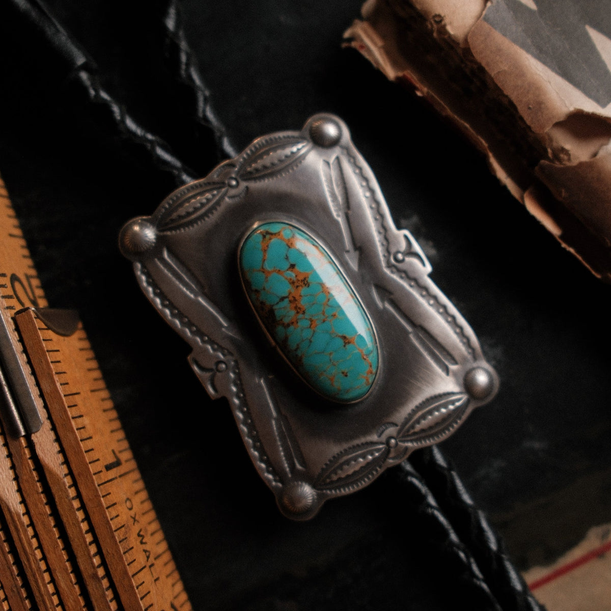 Nevada Royston turquoise on a hand-stamped sterling slide with braided leather cord — one of a kind, made at the bench.