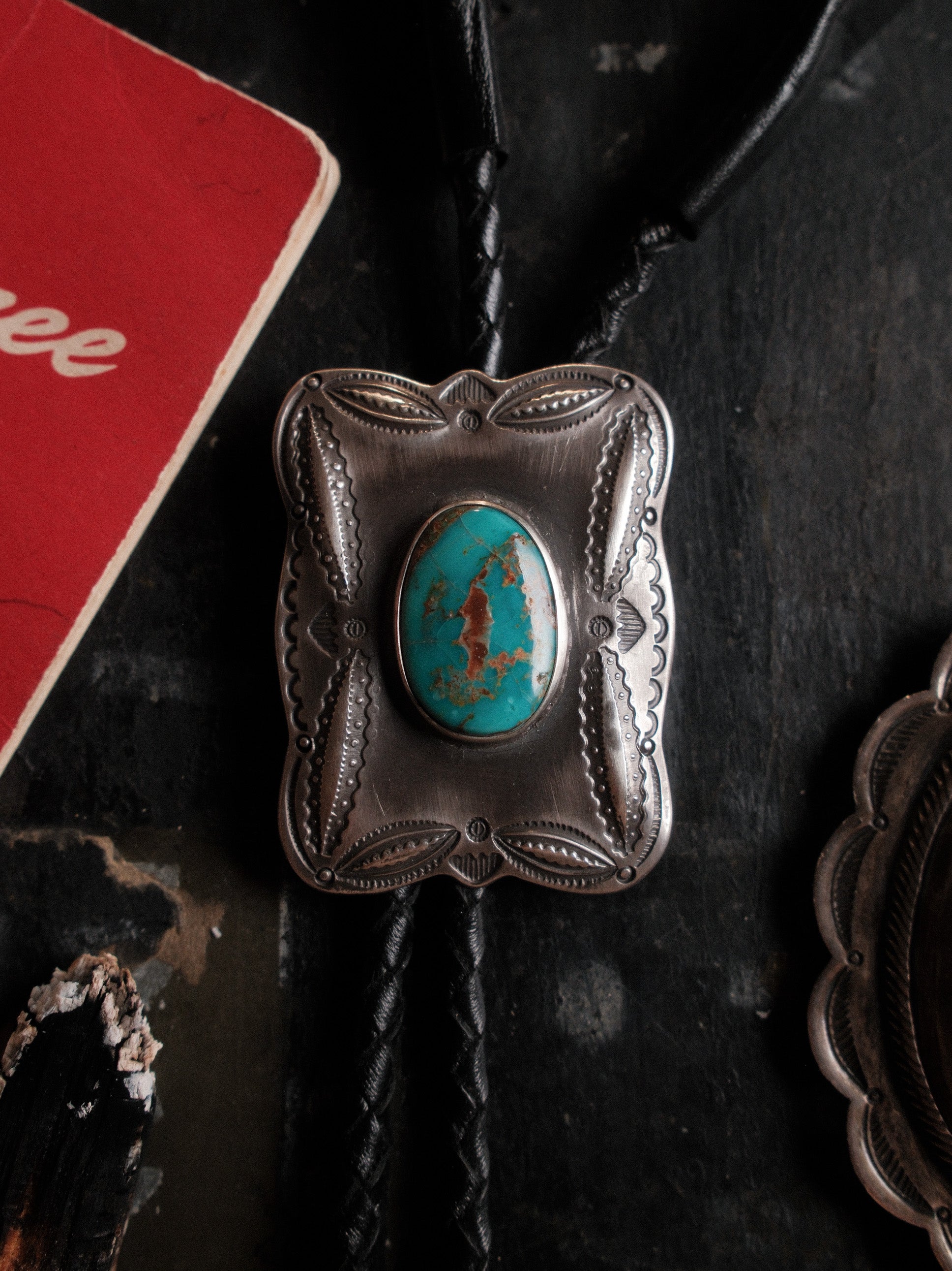 A one-of-a-kind Royston turquoise bolo tie — sterling bump-out stampwork, braided leather cord, sterling end tips — view 2