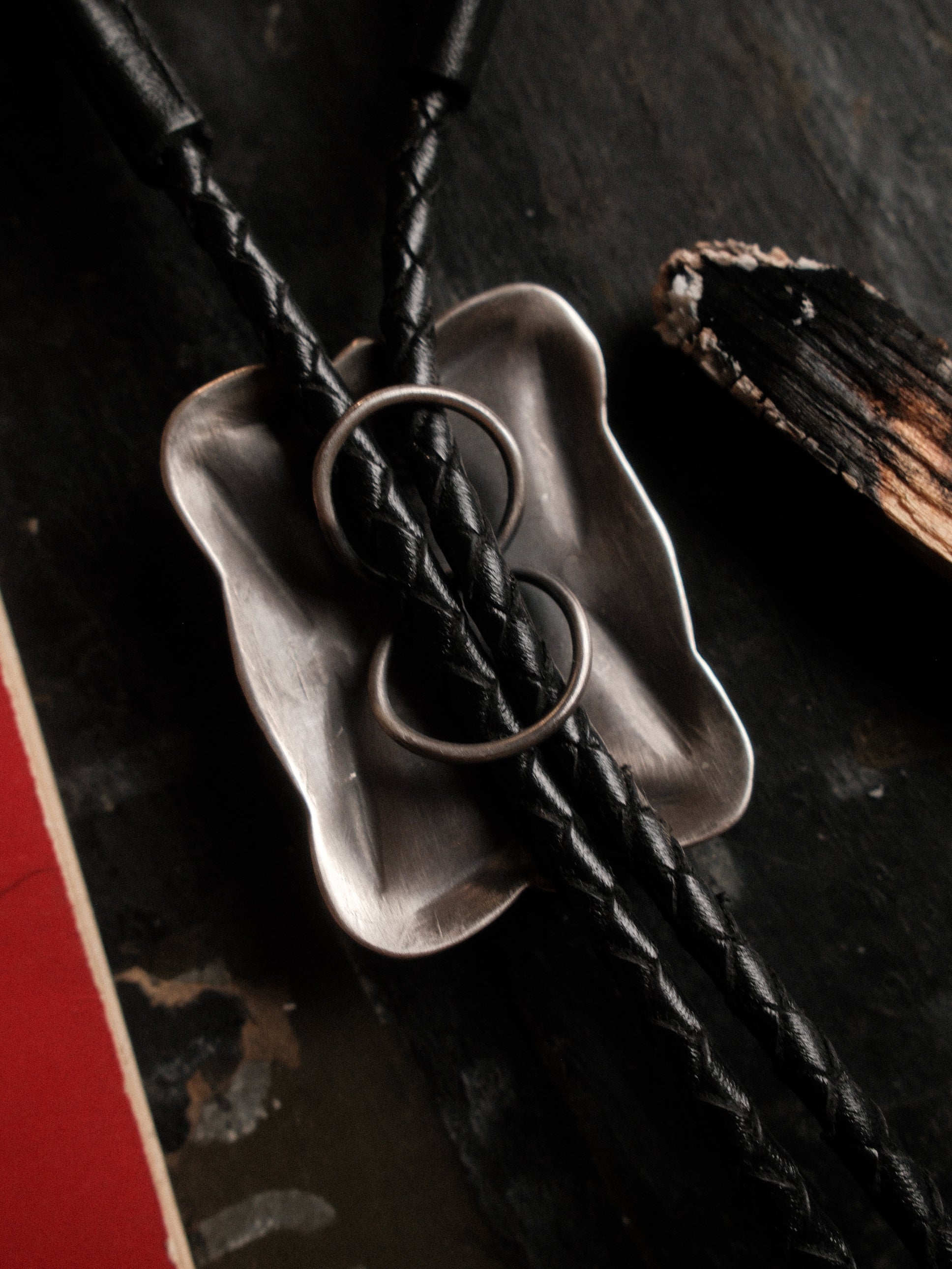 A one-of-a-kind Royston turquoise bolo tie — sterling bump-out stampwork, braided leather cord, sterling end tips — view 4