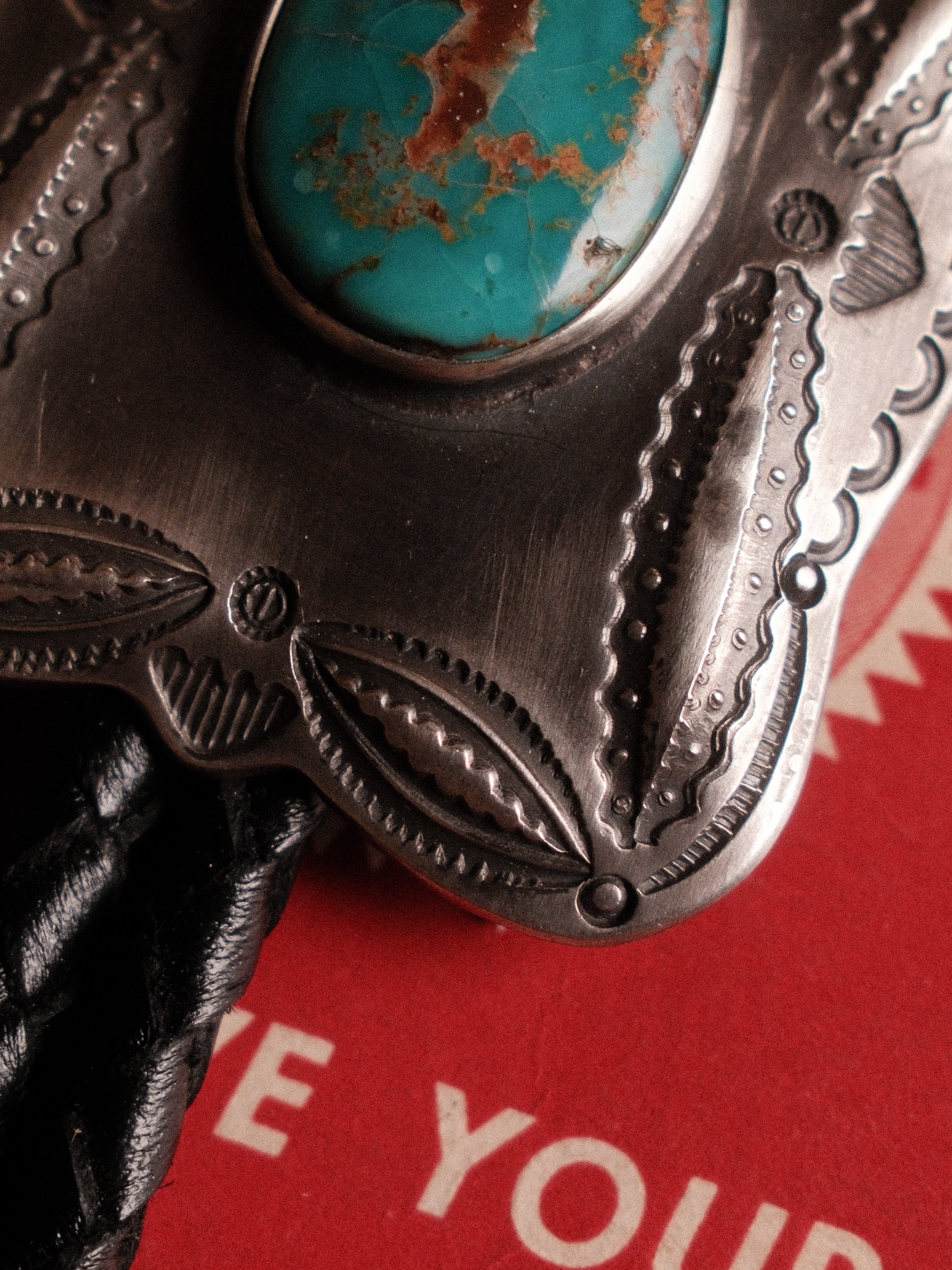 A one-of-a-kind Royston turquoise bolo tie — sterling bump-out stampwork, braided leather cord, sterling end tips — view 6