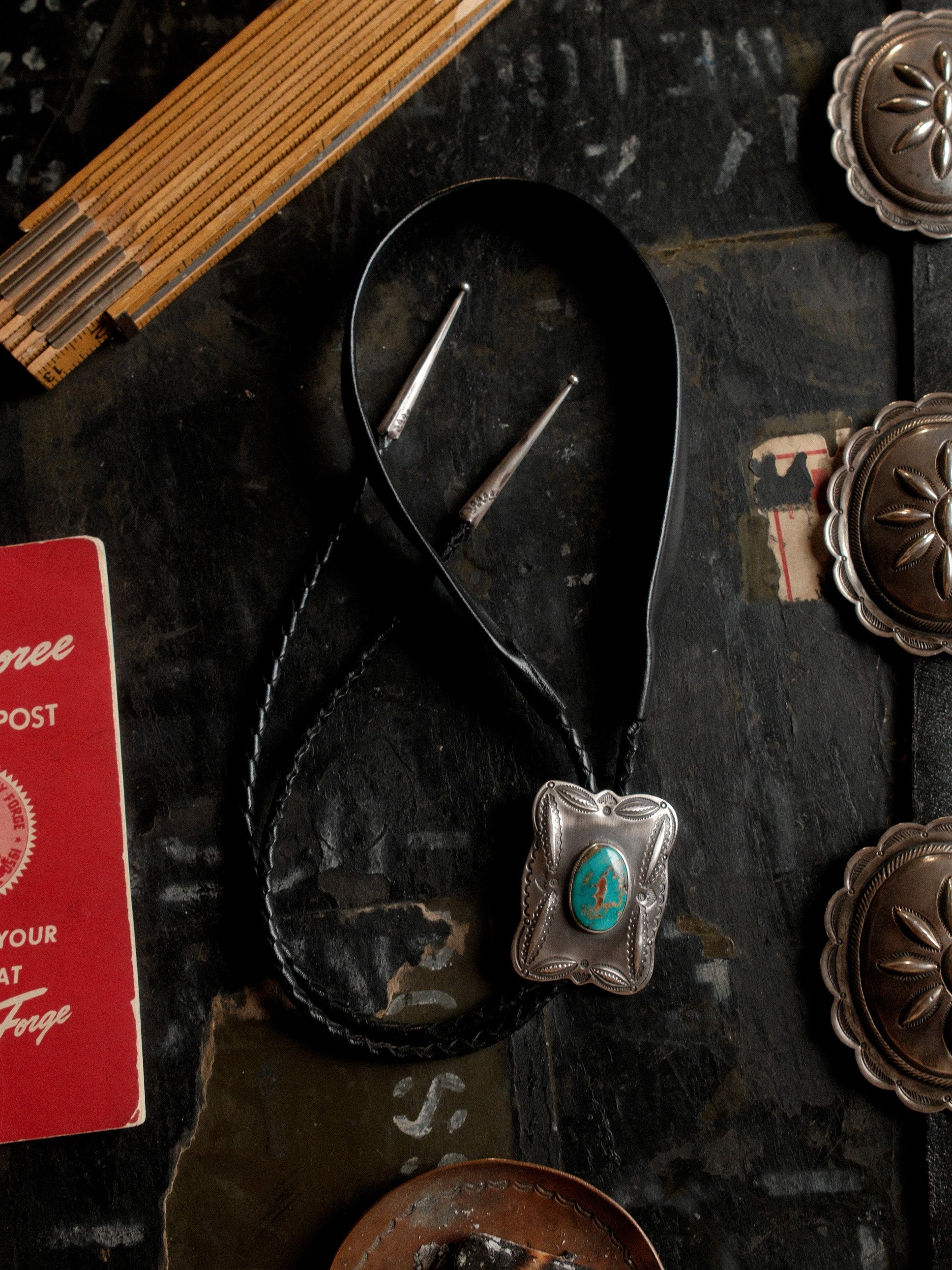 A one-of-a-kind Royston turquoise bolo tie — sterling bump-out stampwork, braided leather cord, sterling end tips — view 3