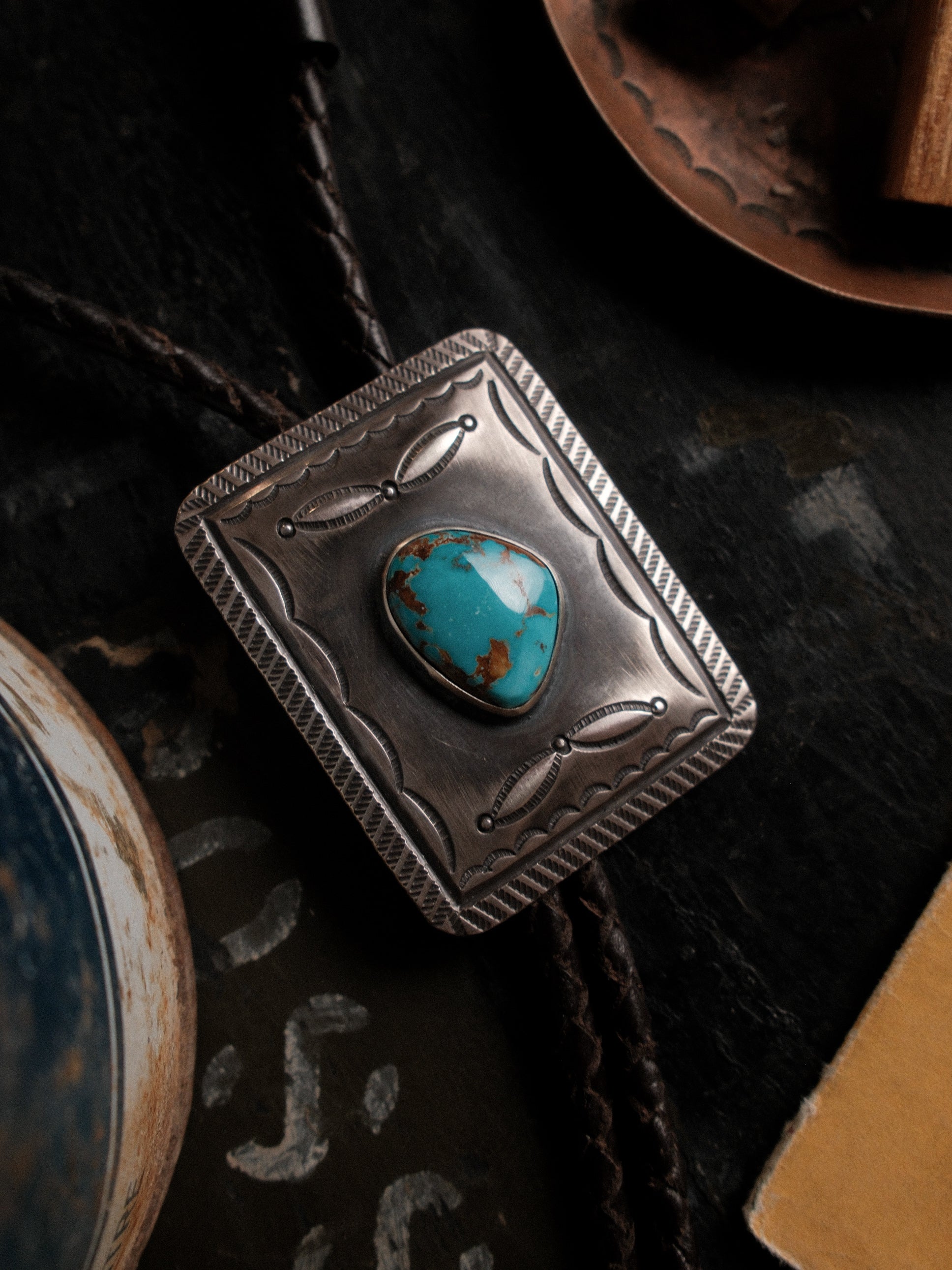 Hand-stamped sterling bolo set with Nevada Royston turquoise on braided leather