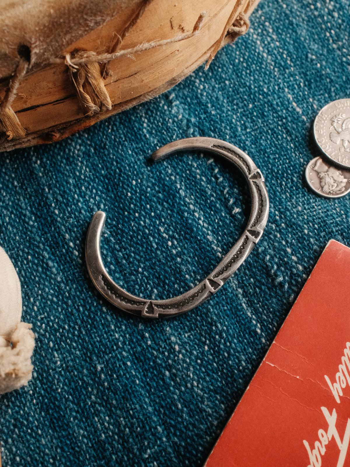 A tufa-cast coin-silver ingot cuff, intricately hand-stamped with Chad's own steel and left in its raw casting texture