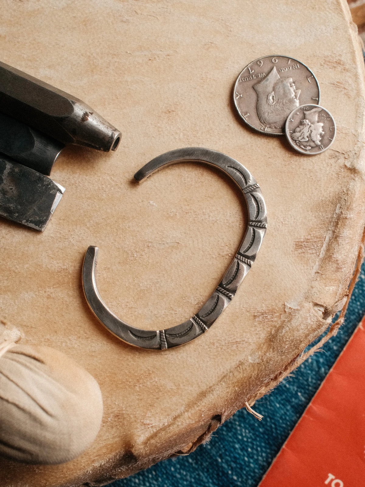 Poured from a tufa-cast coin-silver ingot and hand-stamped throughout, its cast surface left intact